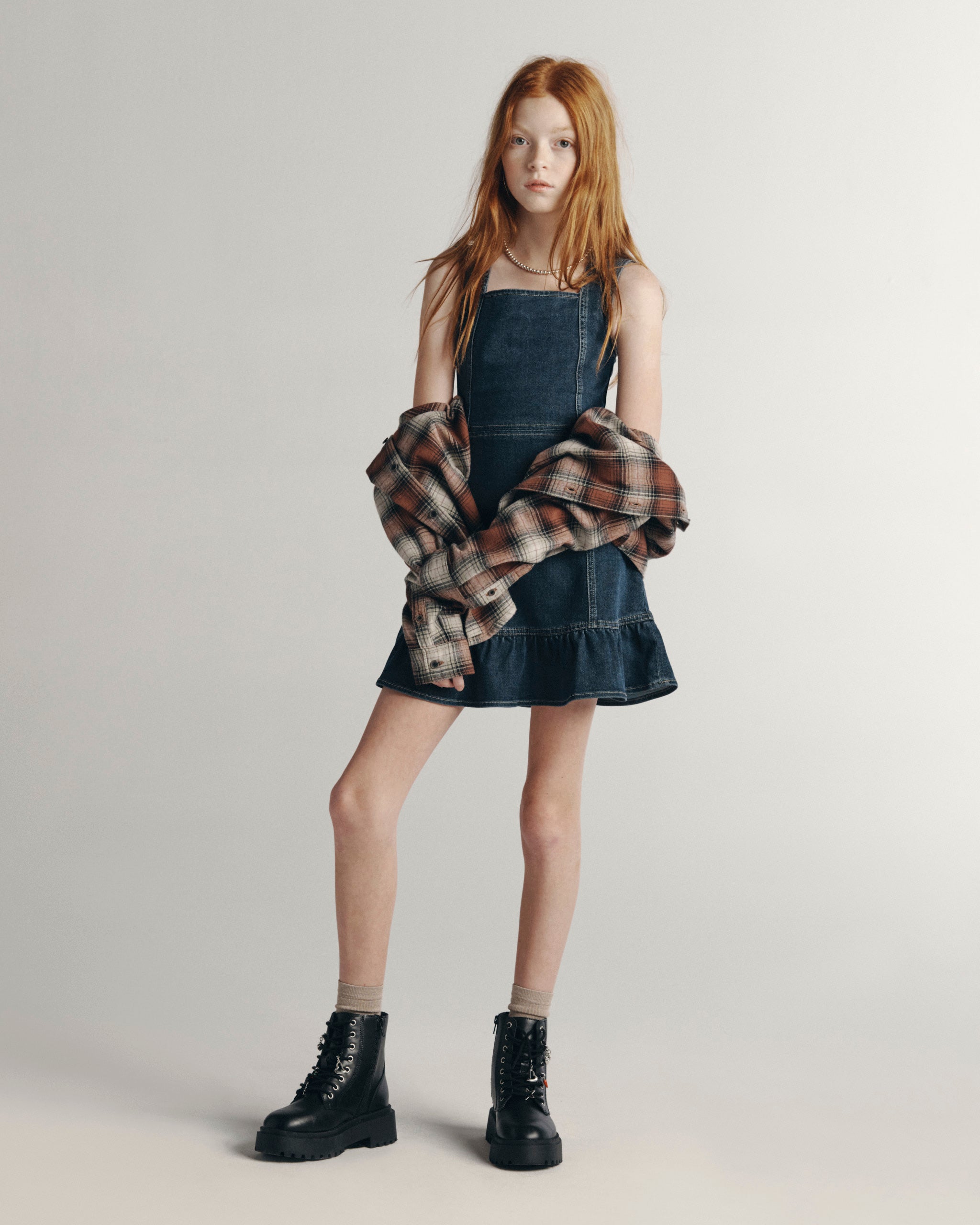 DL1961 Kids girls' Bety square neck dress in Nightlight with a plaid flannel and lace-up boots, full-length front, studio.