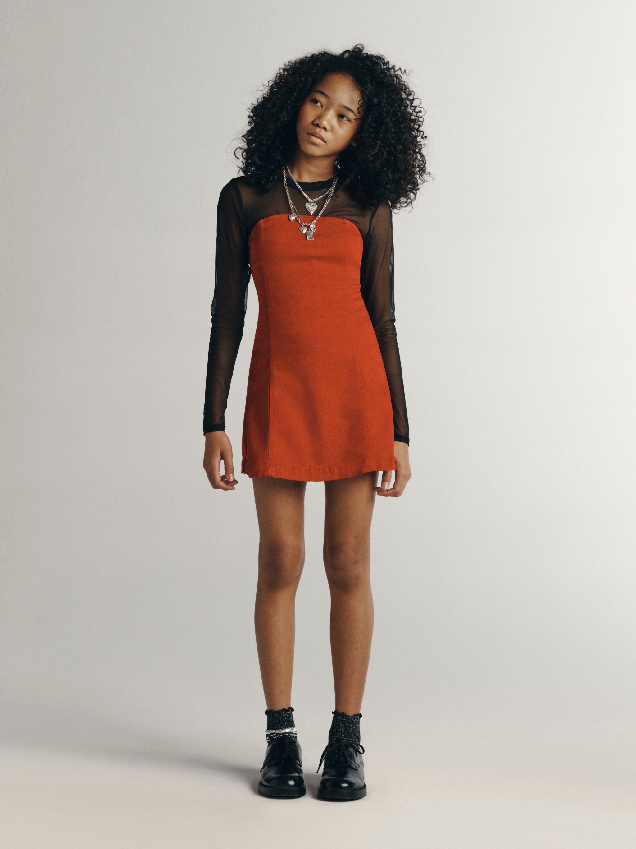 DL1961 Kids girls' Bety strapless dress in Rouge over a black mesh top, full-length front three-quarter view, studio.