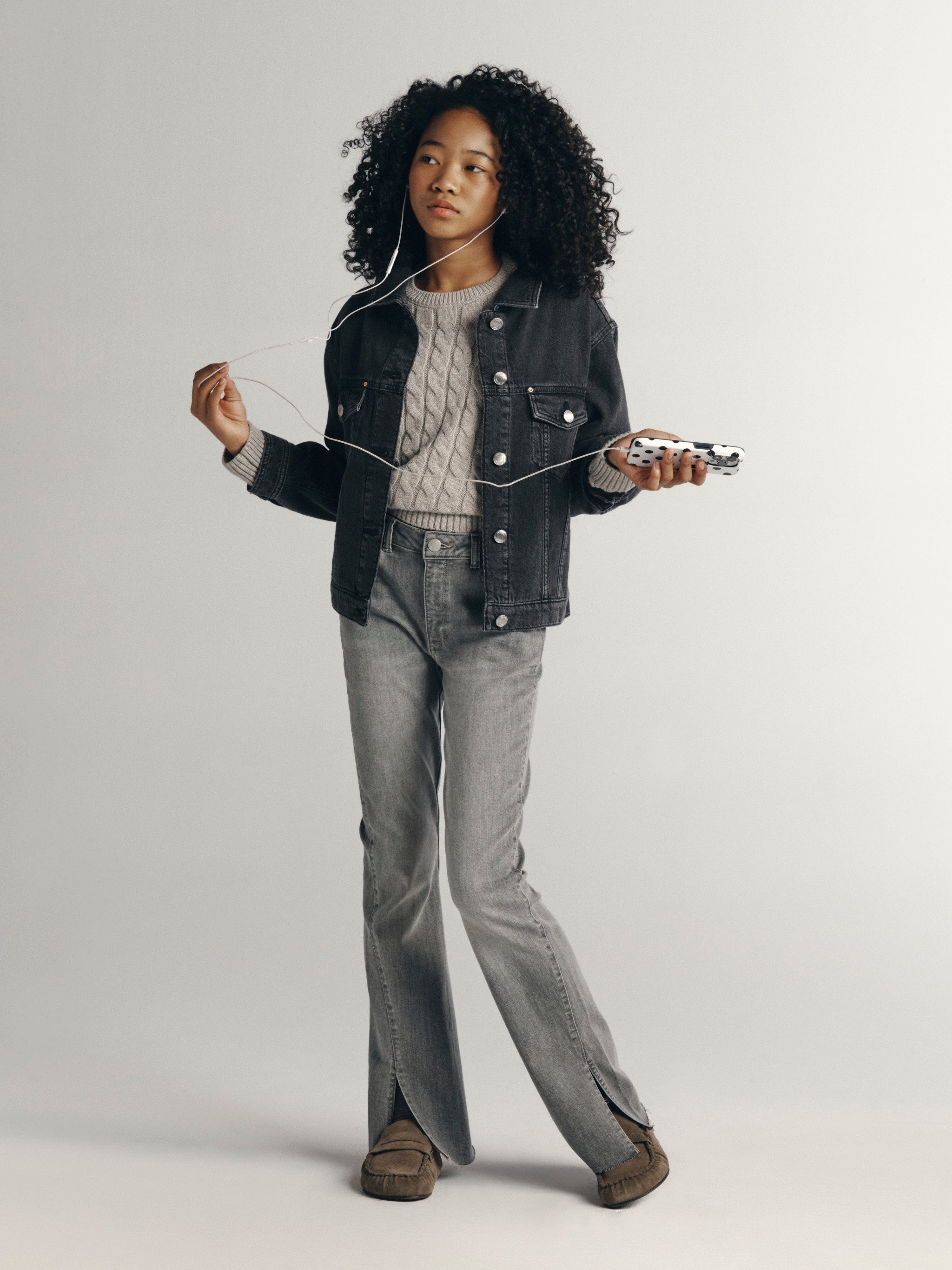 DL1961 Kids girls' Claire bootcut jeans in Twister with a grey Jordyn trucker jacket and cable-knit sweater, full-length front, studio.