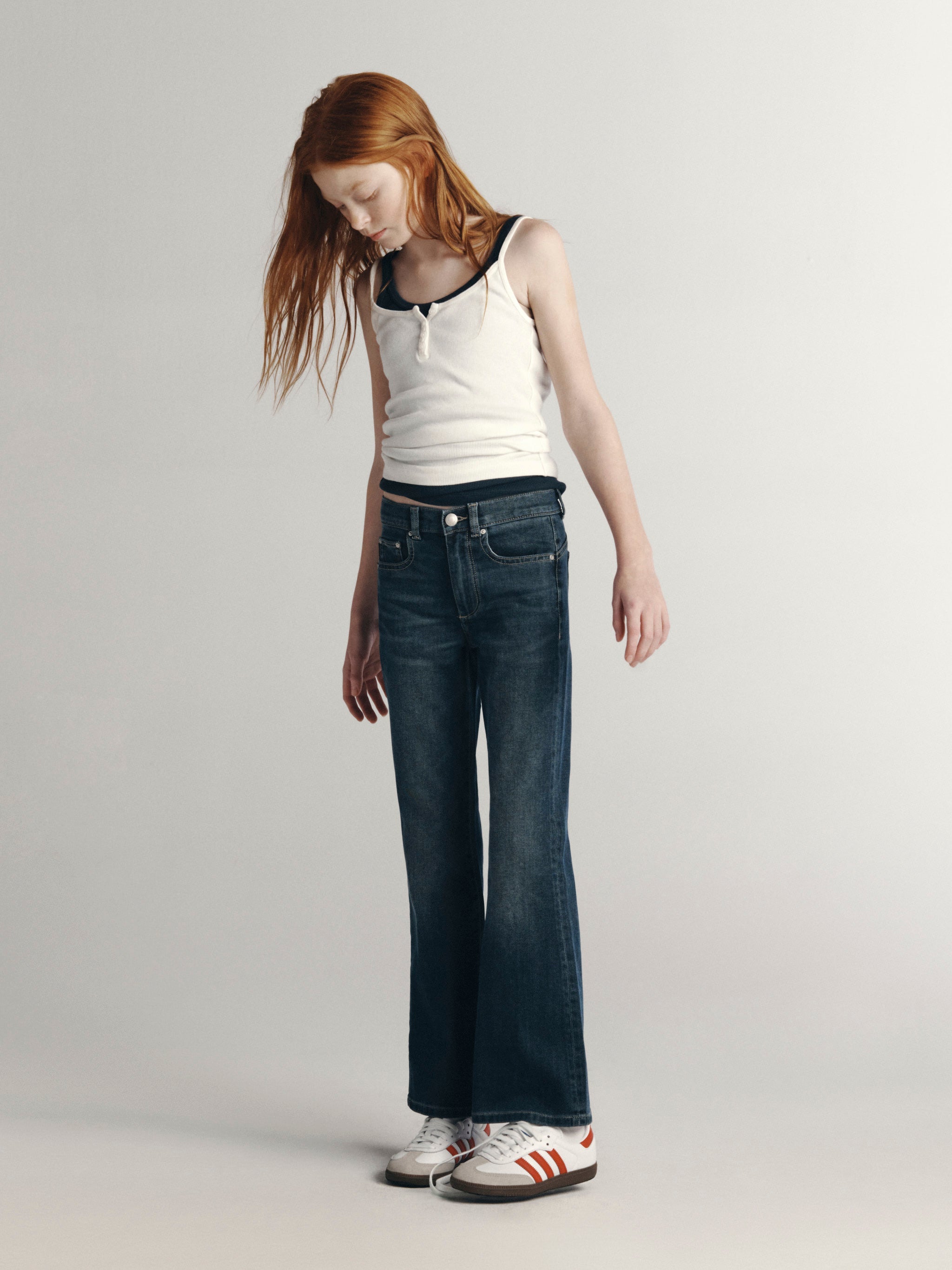 DL1961 Kids girls' Cleo bootcut jeans in Nightlight with a white ribbed tank, full-length front view in a studio.