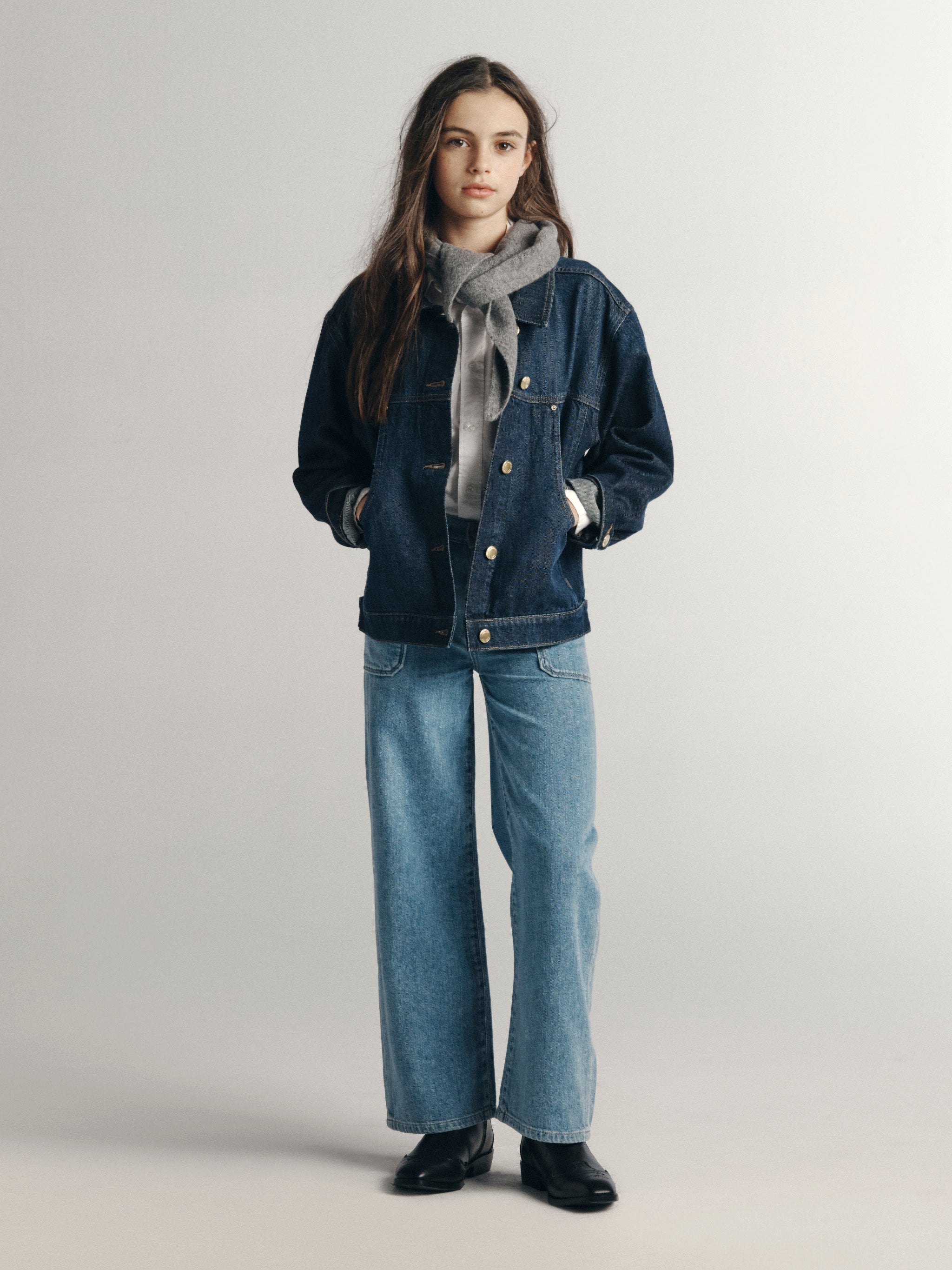 DL1961 Kids girls' Lily wide-leg jeans in Sky Fade with a denim jacket and grey sweater, full-length front view in a studio.