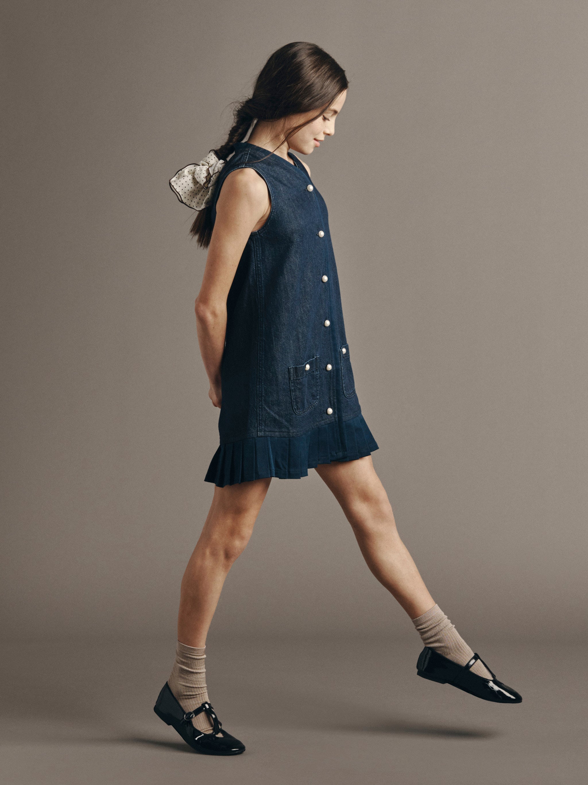 DL1961 Kids girls' Manning vest dress in Deep Water, full-length walking side view in a studio.