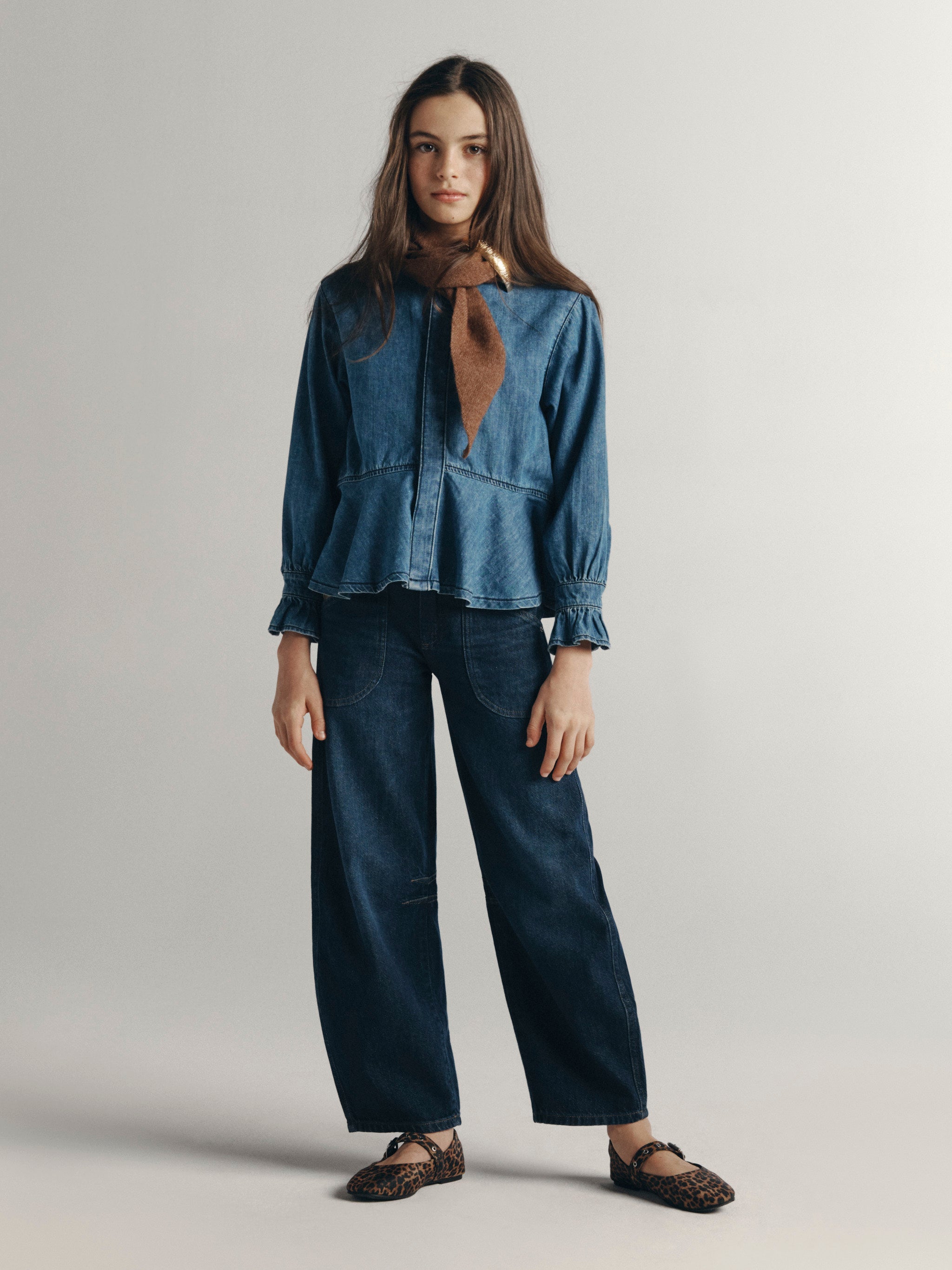 DL1961 Kids girls' Lilia barrel jeans in Deep Water with a chambray Simona top in Blue Dream and leopard flats, full-length front, studio.
