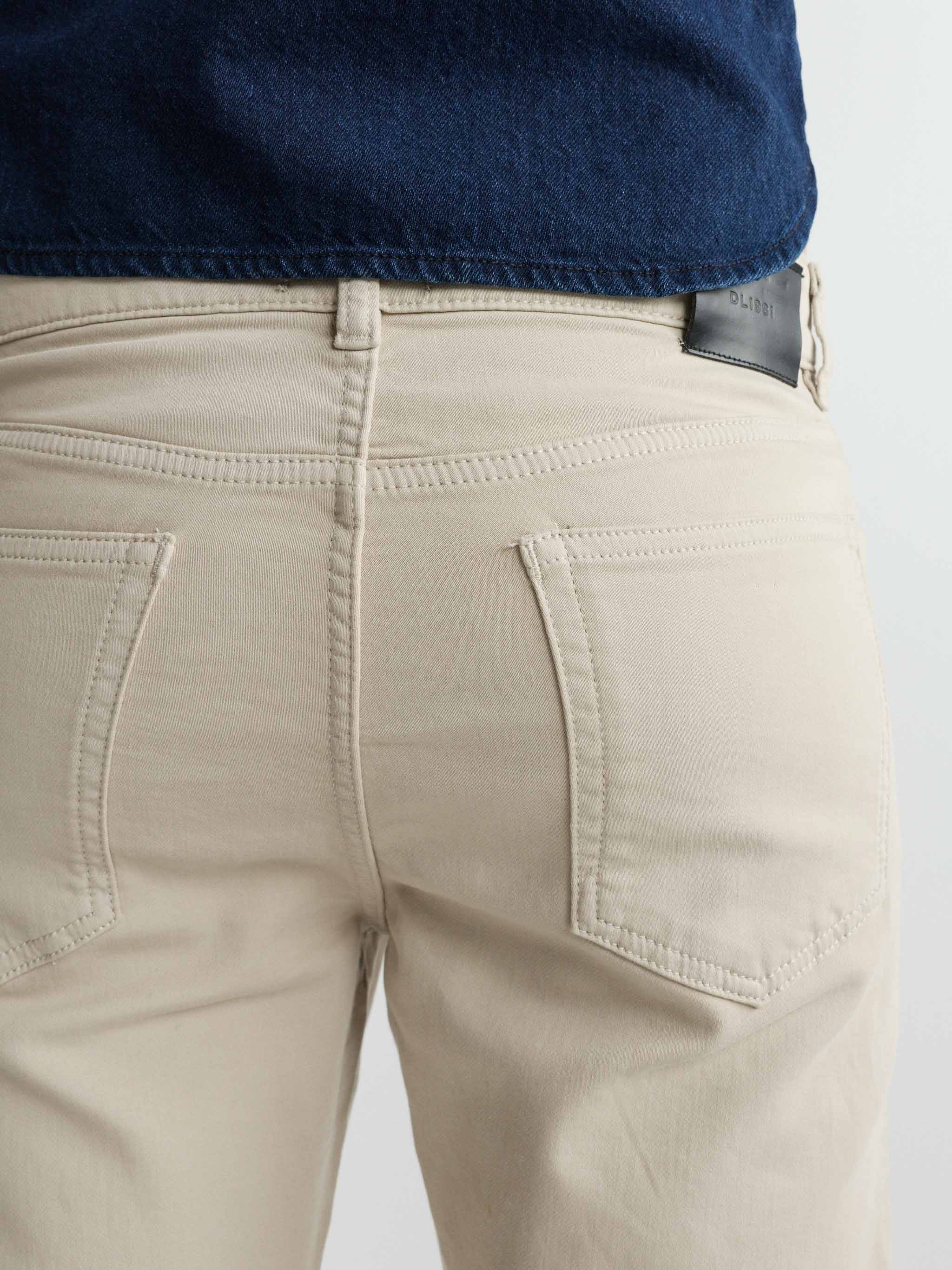Beige pants with a navy shirt on a light gray background