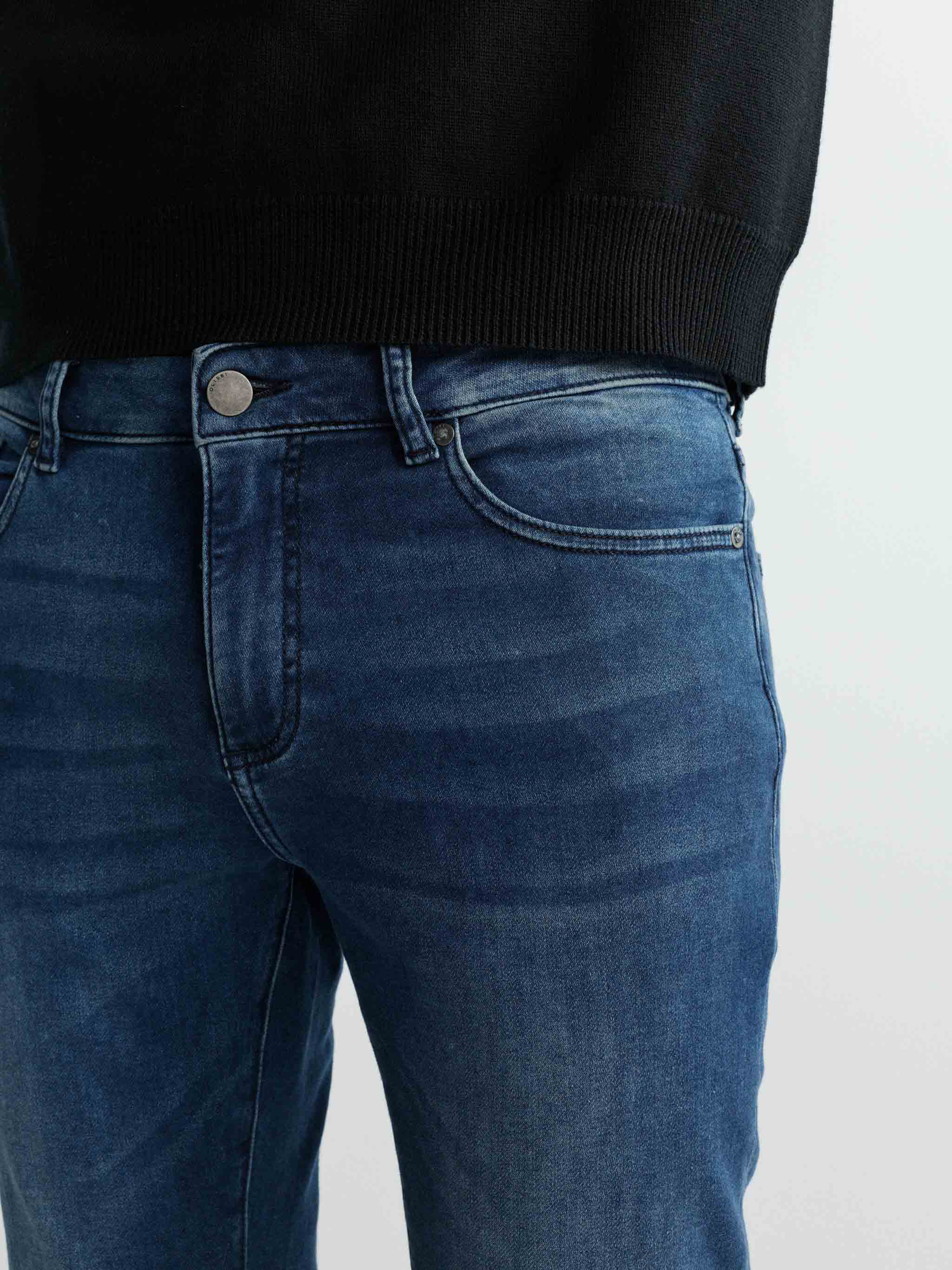 Blue jeans worn by a person on a white background