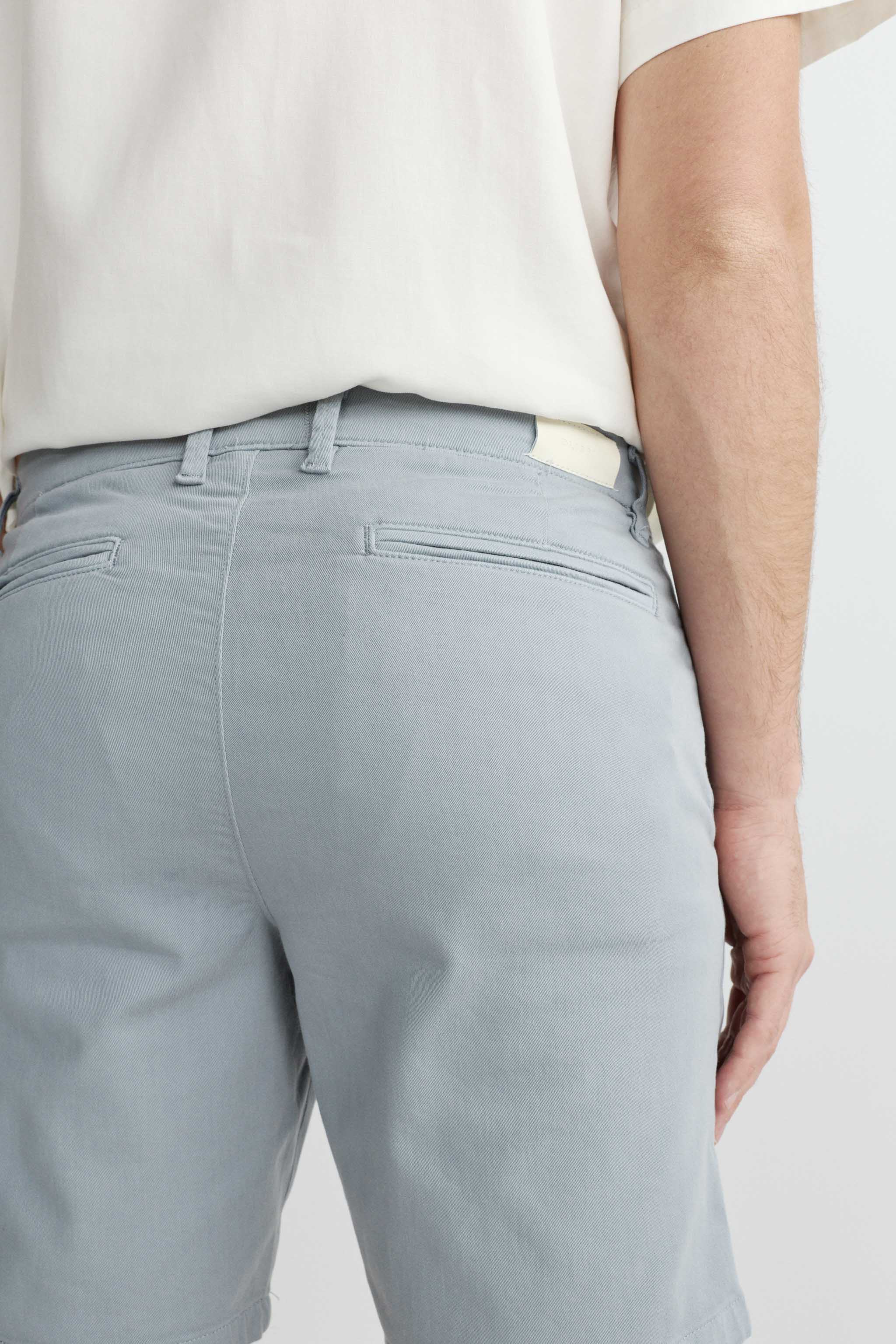 Light gray pants worn by a person on a white background