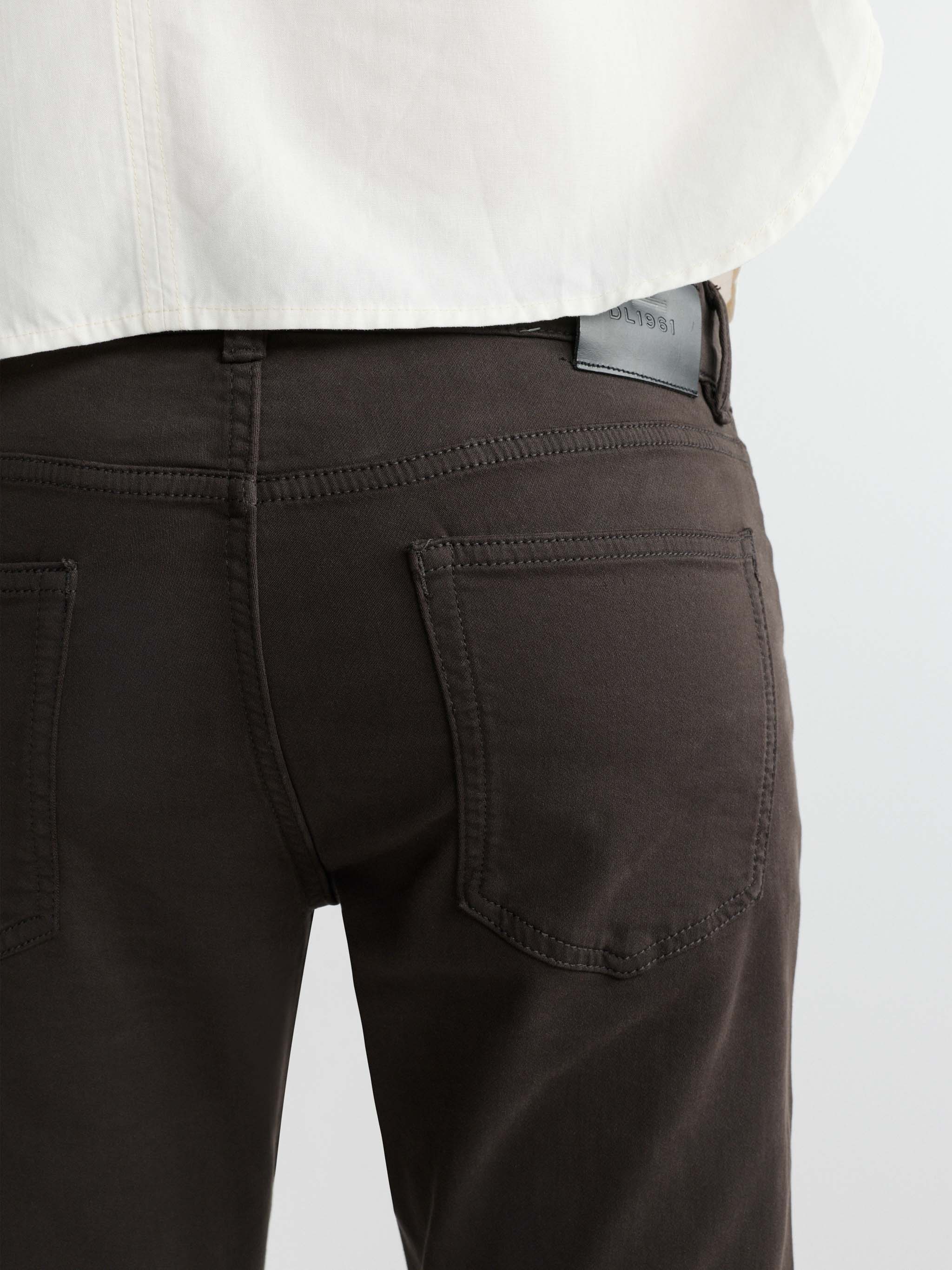 Brown pants with a visible brand logo on a white background