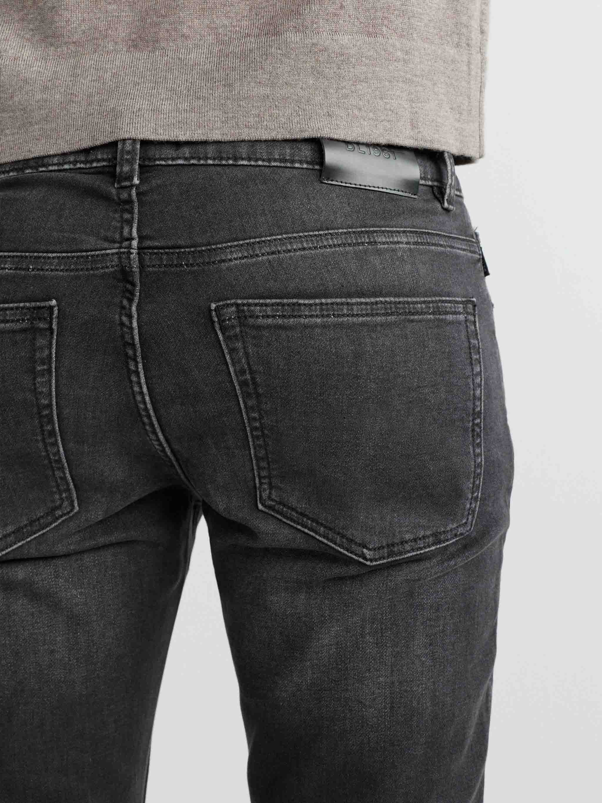 Black jeans worn by a person on a light gray background