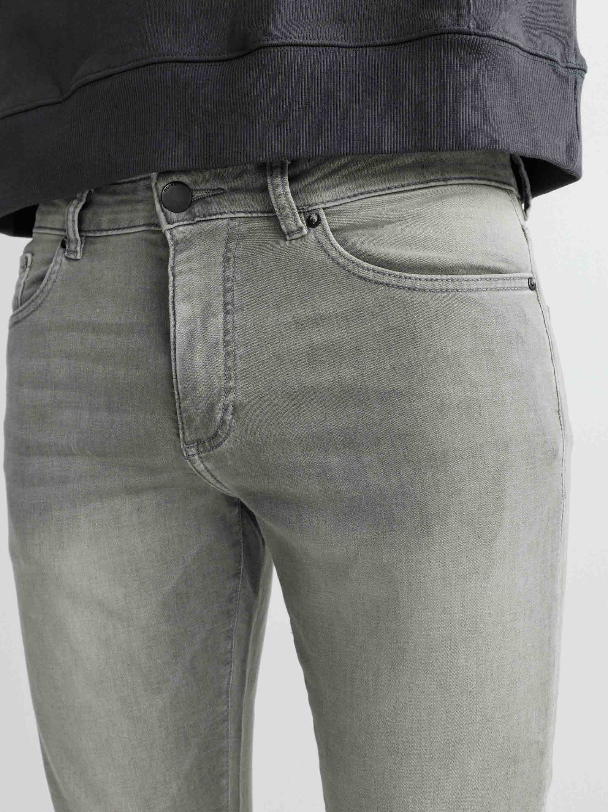 Gray jeans worn by a person on a light gray background