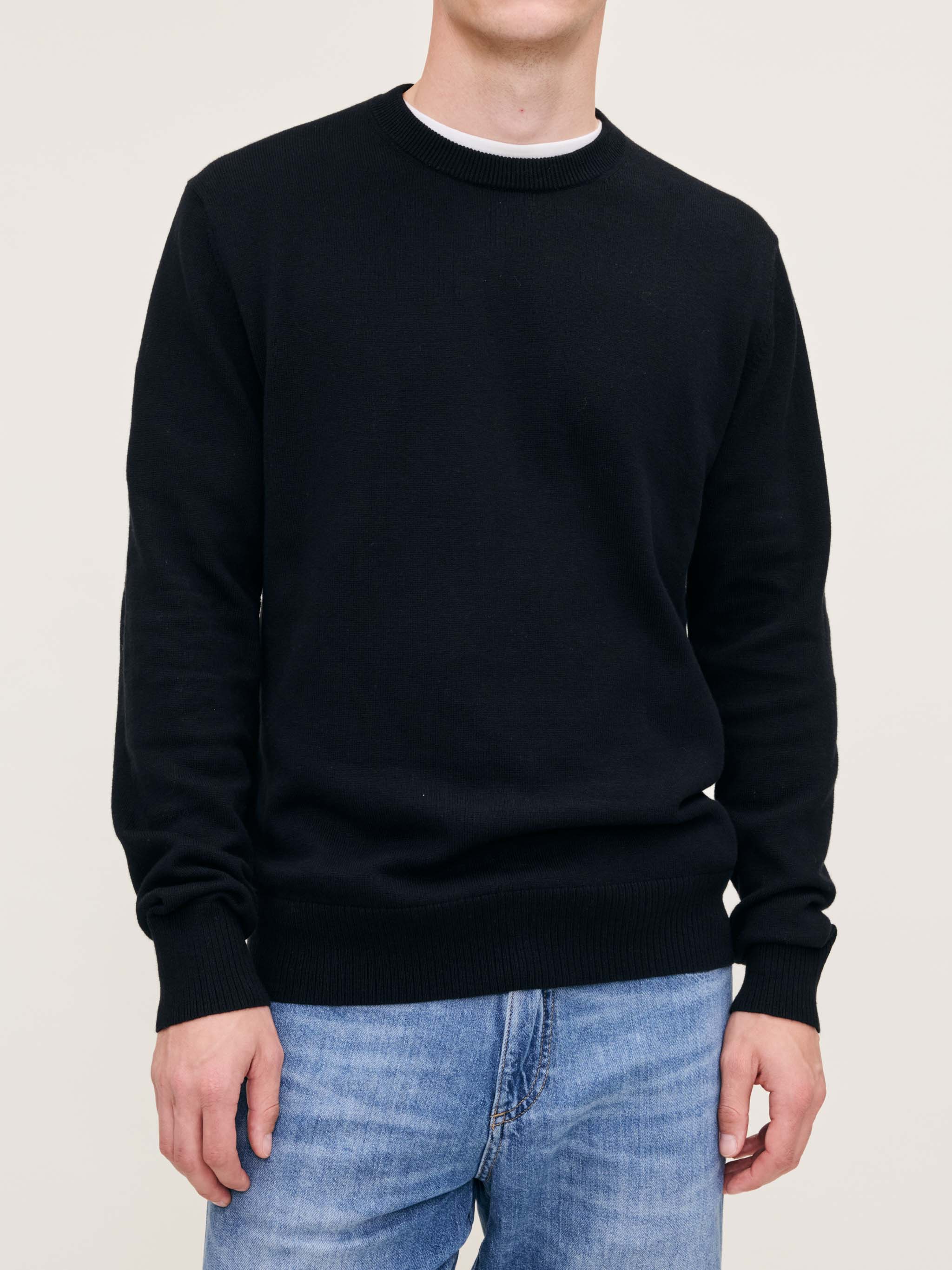 DL1961 men's Classic Crewneck sweater in black, three-quarter front view on model over white tee.