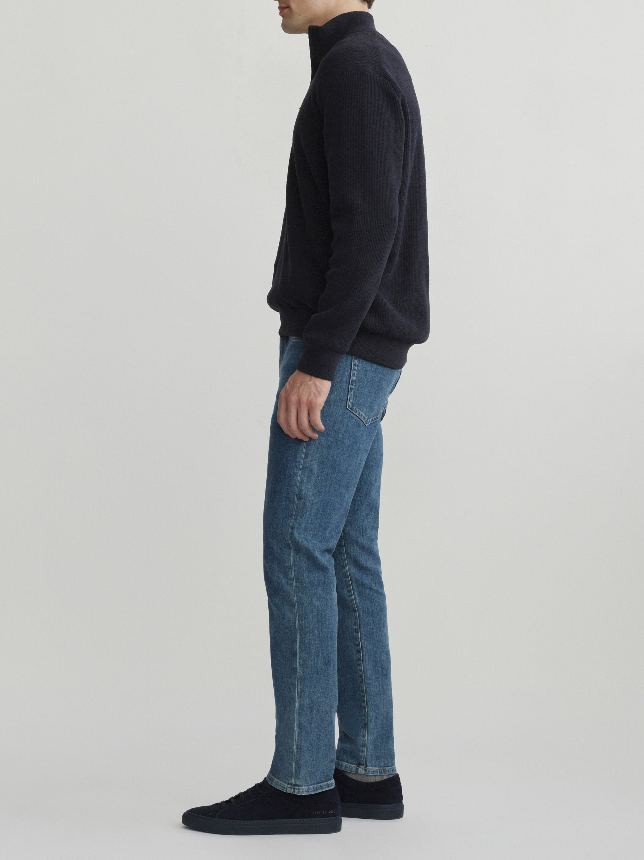 DL1961 men's Russell Slim Straight jeans in medium blue 'Highland Park', side profile view showing the straight leg.