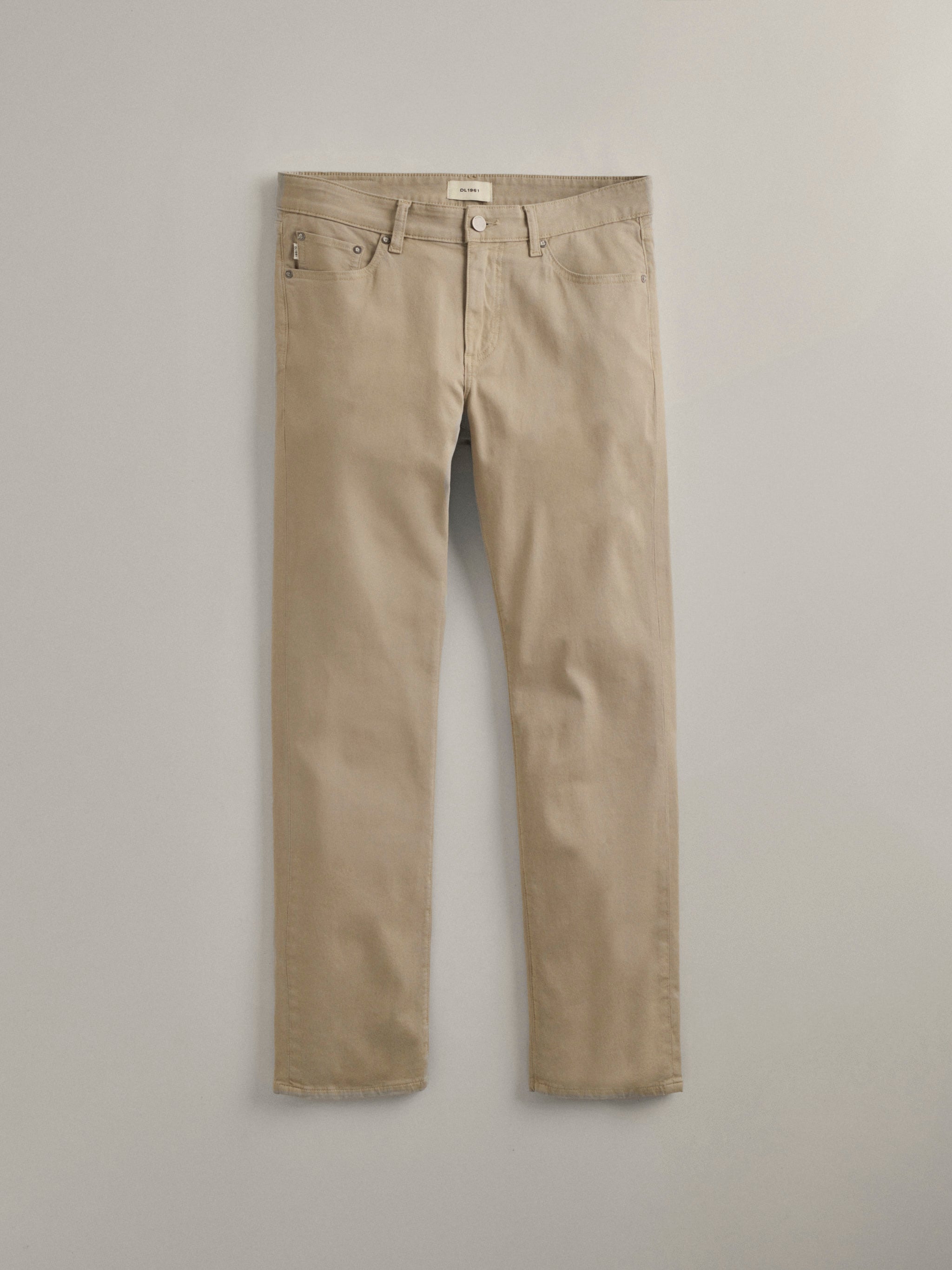 DL1961 men's Russell Slim Straight pants in light taupe, flat lay front view in soft stretch twill.