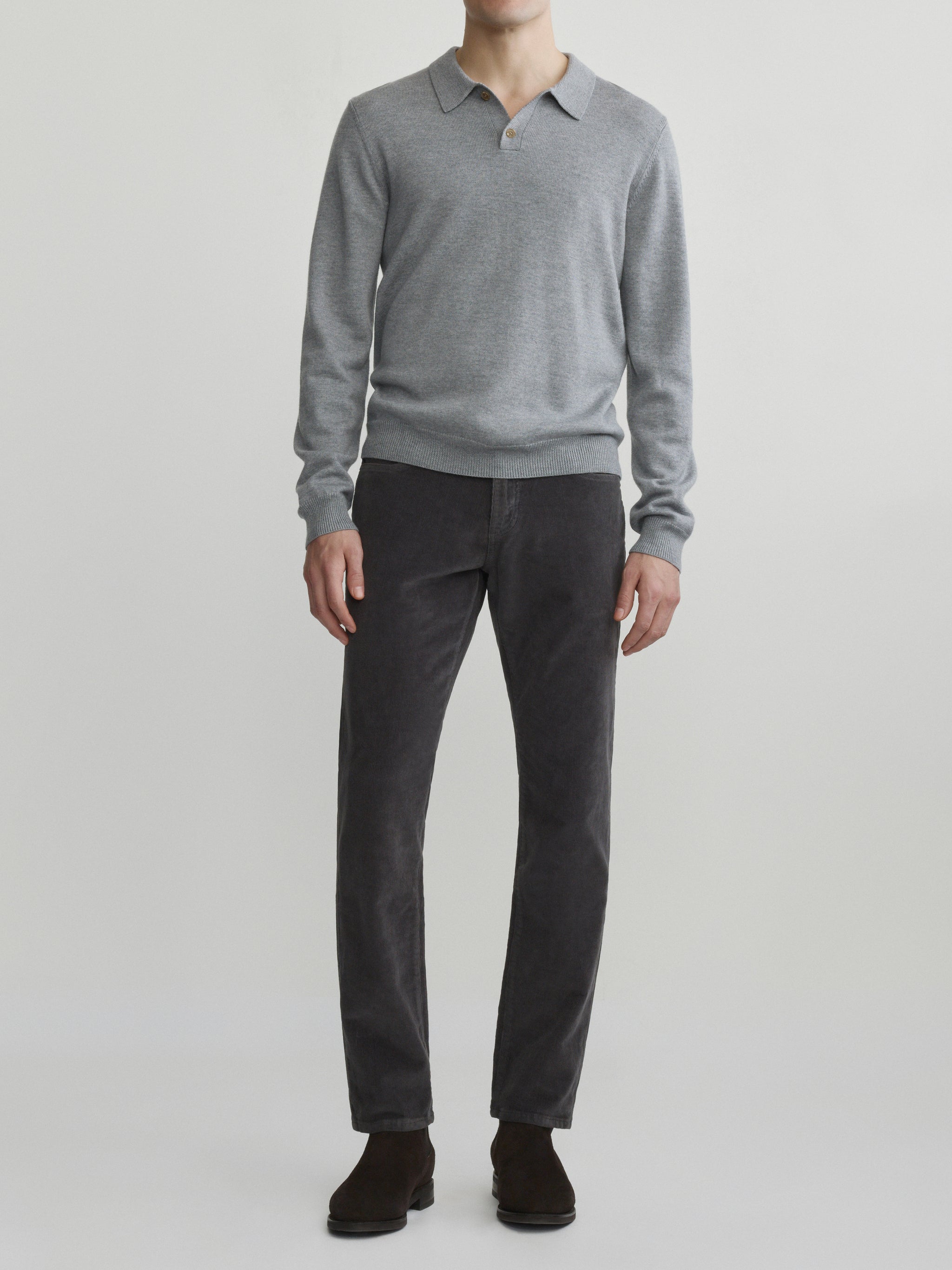 DL1961 men's long-sleeve knit polo in grey melange, full-length front with charcoal cords and brown boots