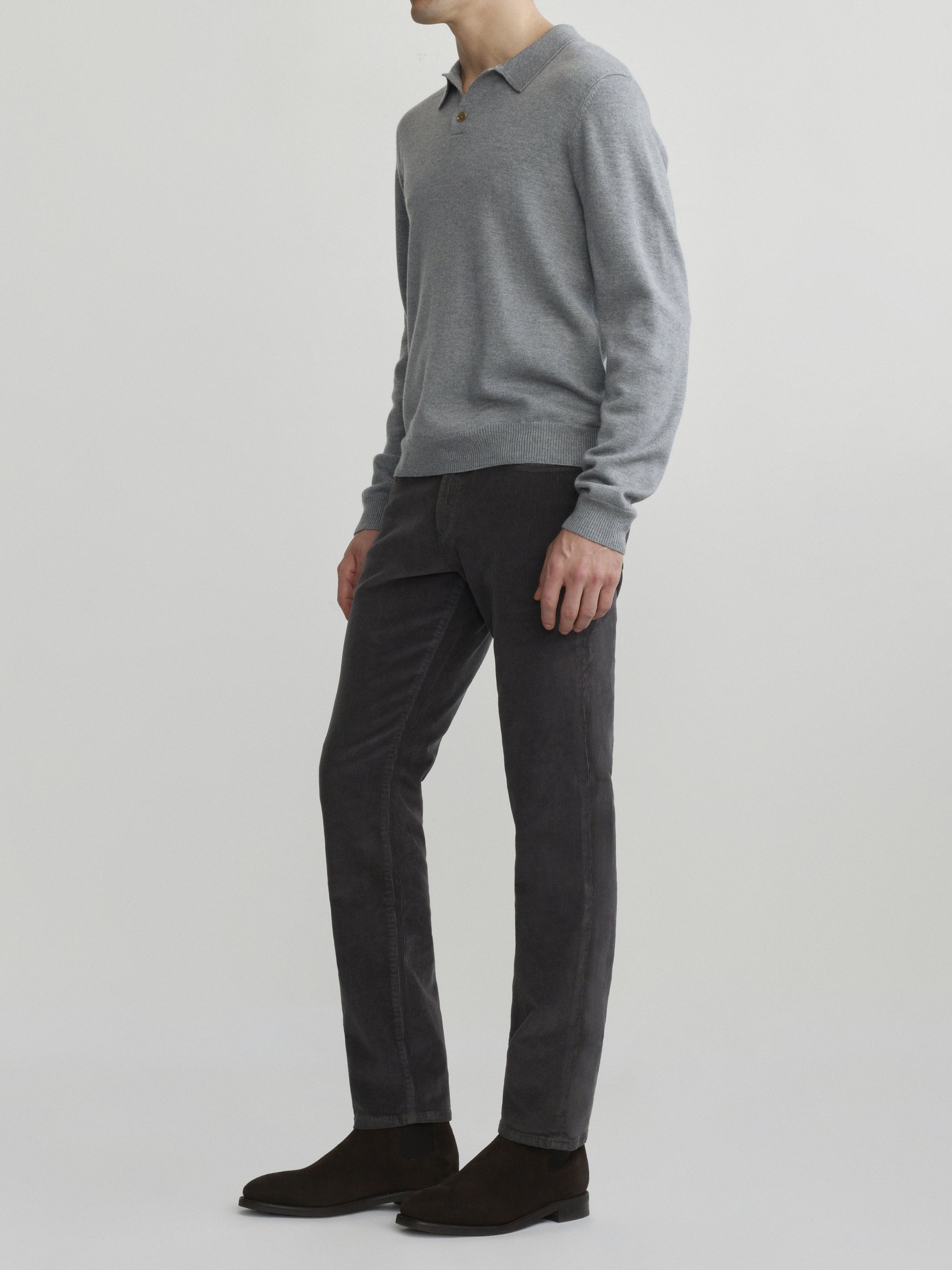 DL1961 men's long-sleeve knit polo in grey melange, full-length side with charcoal corduroy pants