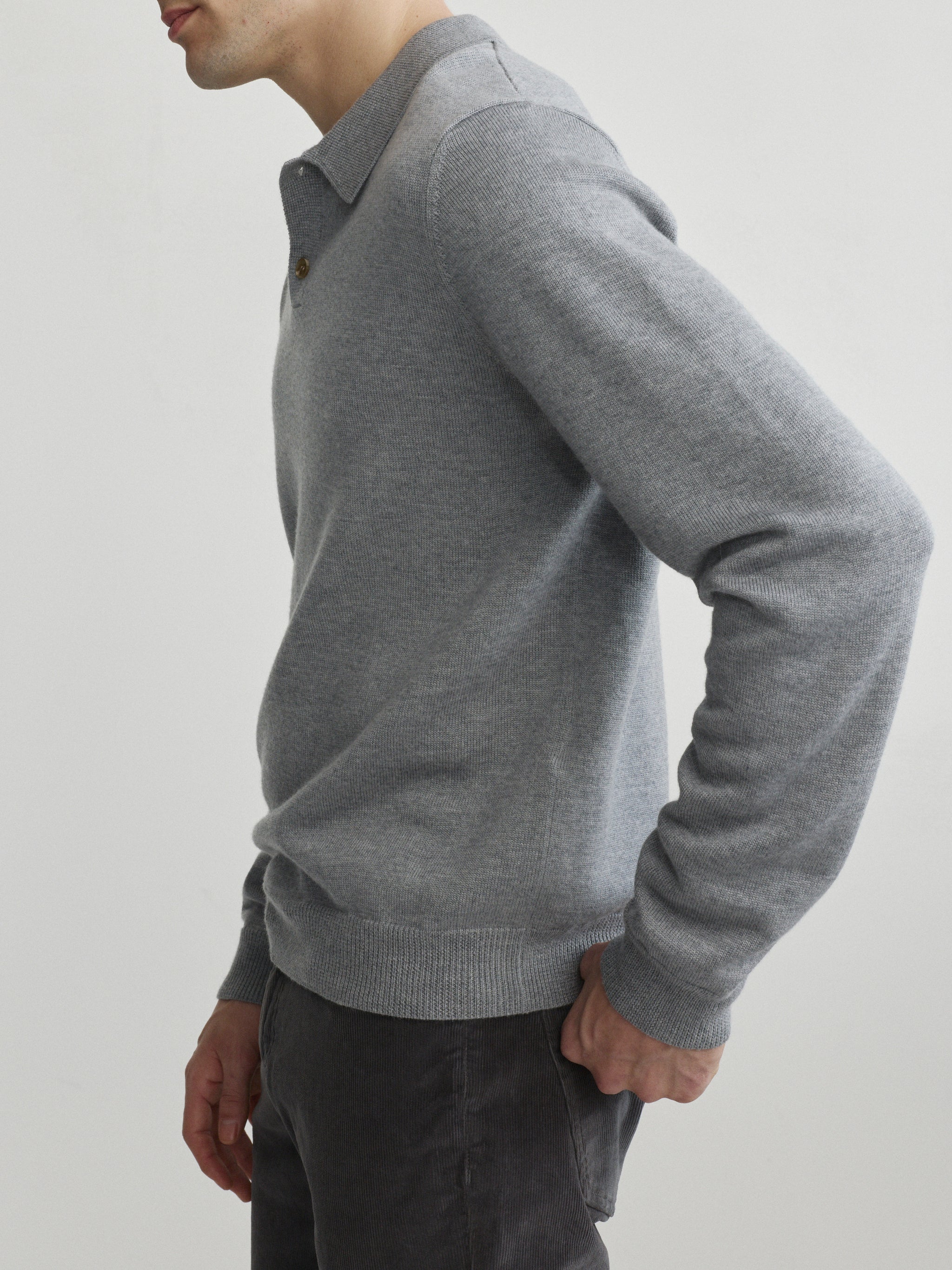 DL1961 men's long-sleeve knit polo in grey melange, side view showing ribbed cuff and hem