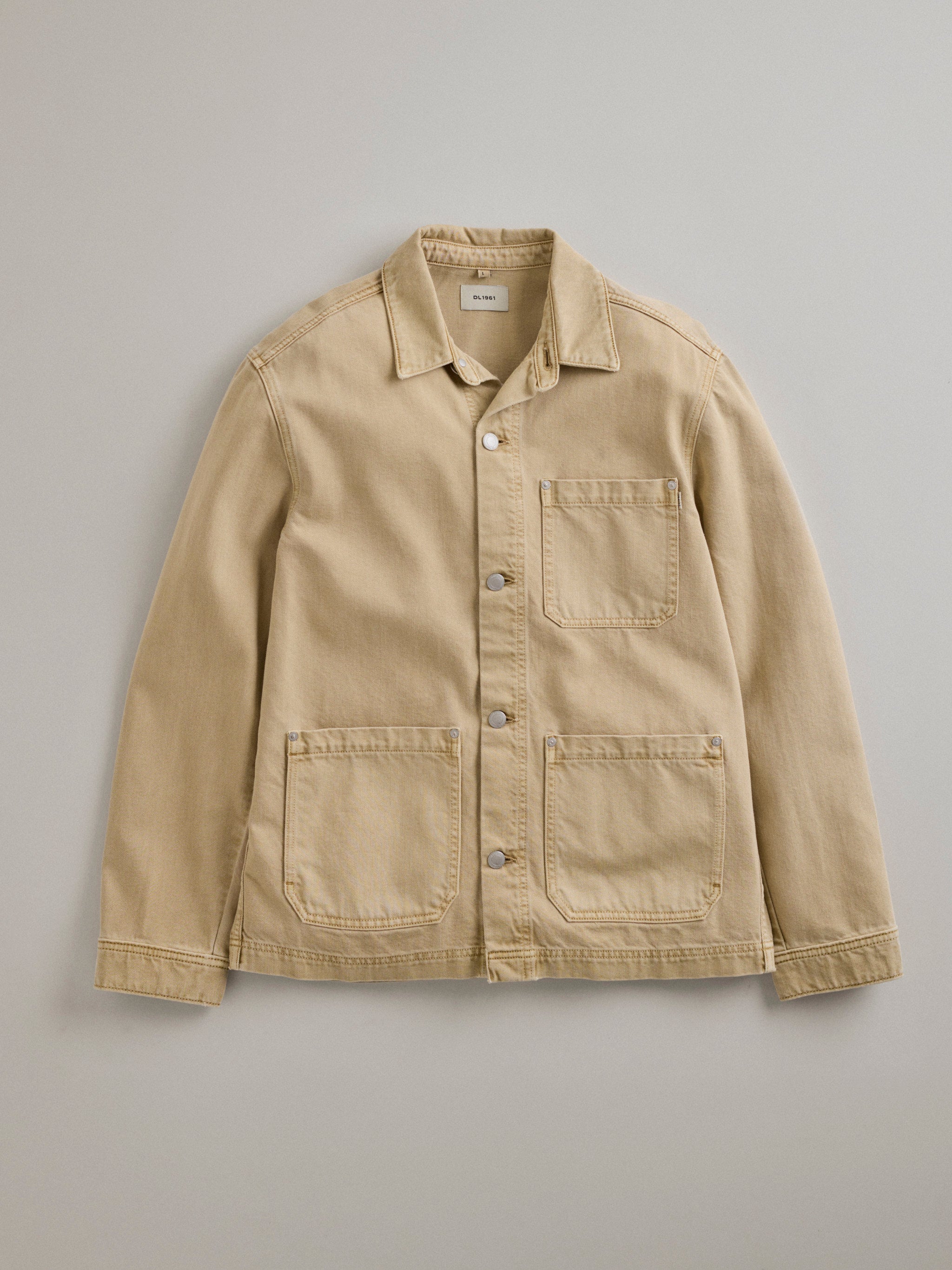 DL1961 men's Sean denim shirt jacket in sand 'Dune', flat lay front view with three patch pockets and snap front.