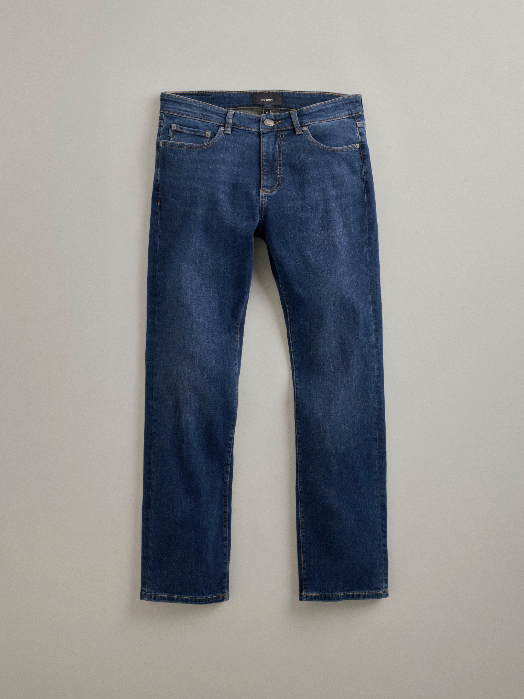 DL1961 men's Russell Slim Straight jeans in dark indigo 'Reader', flat lay front view with soft fading through the leg.