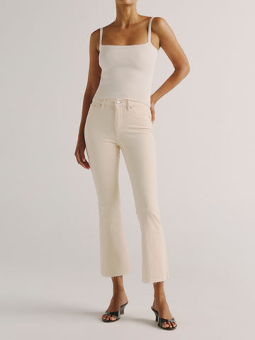 DL1961 women's Bridget Boot High Rise Instasculpt crop jeans in ivory 'Flax', front view styled with a white tank and black sandals.