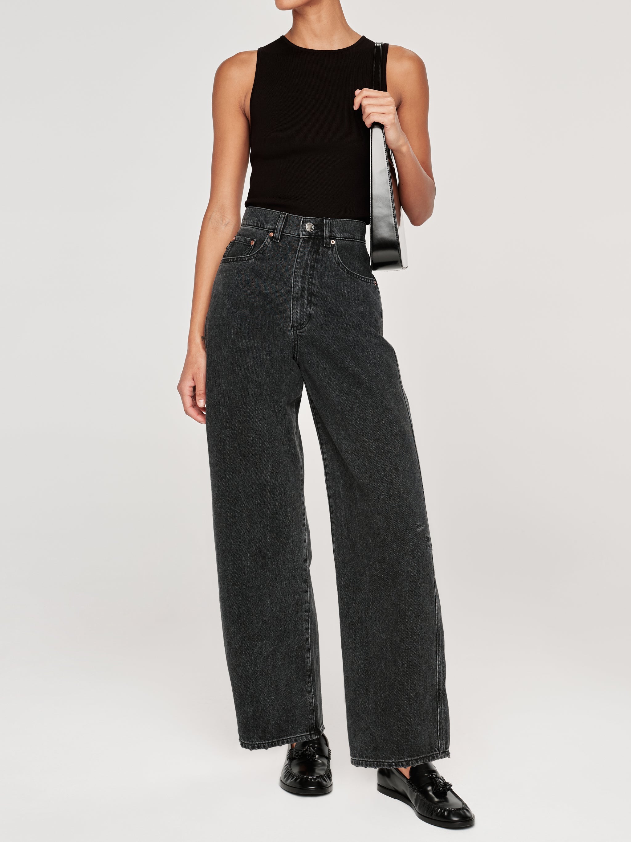 Taylor jeans in Nightshade on a model with a black tank and shoulder bag, full-length front view.