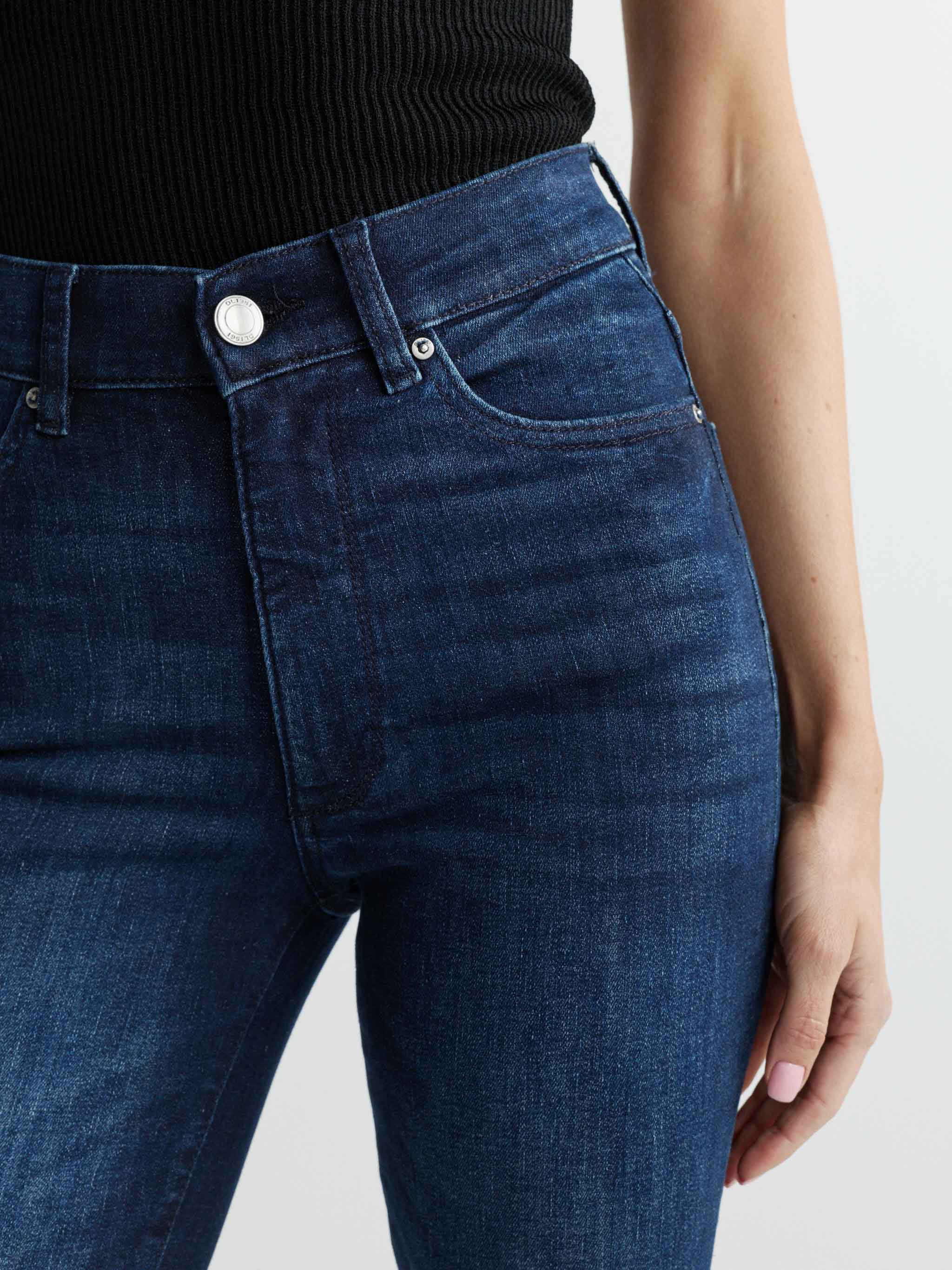 Close-up of blue jeans with a plain background