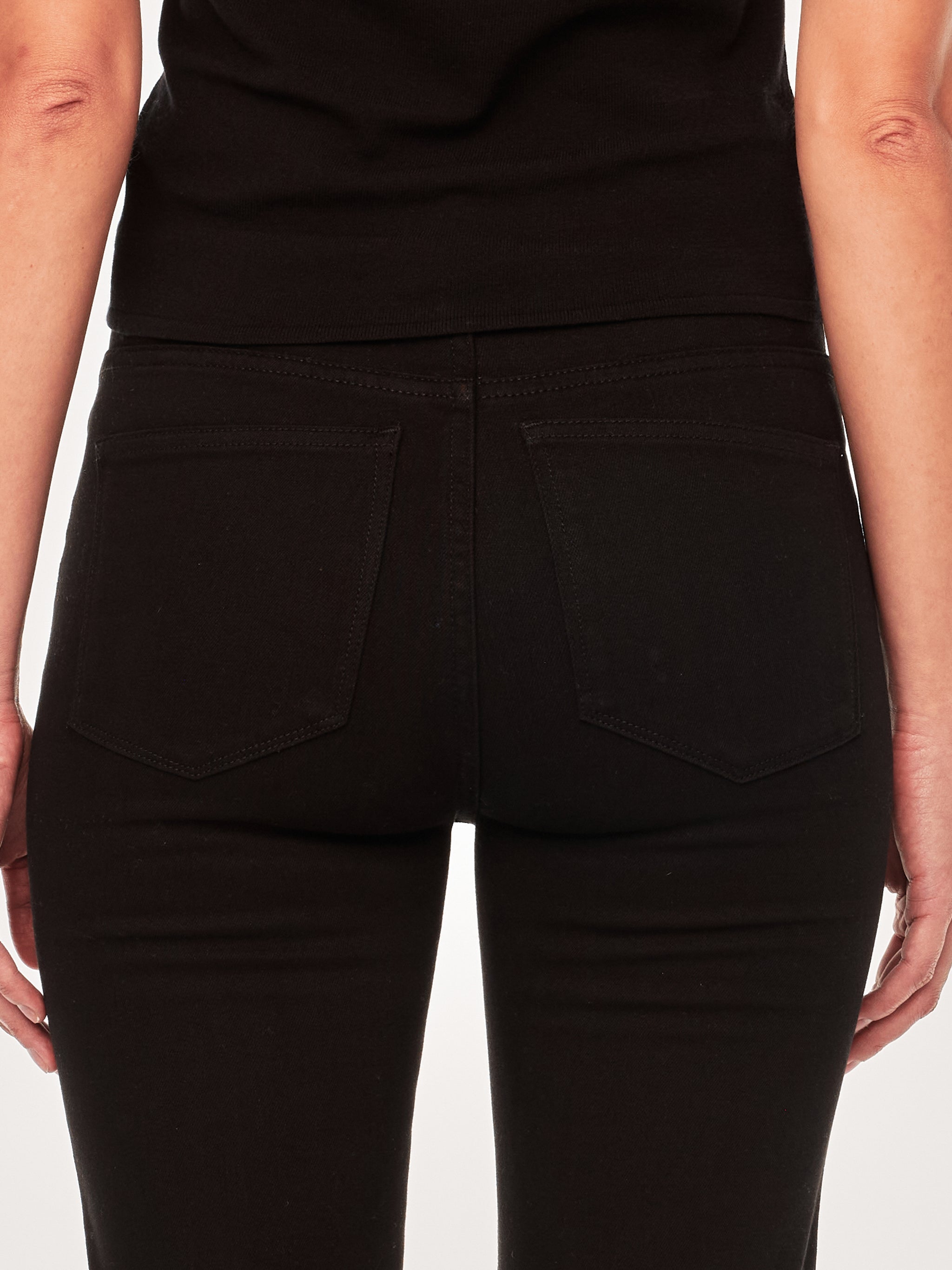 Halle jeans in Black Peach on a model in a black tee, full-length back view in a studio.