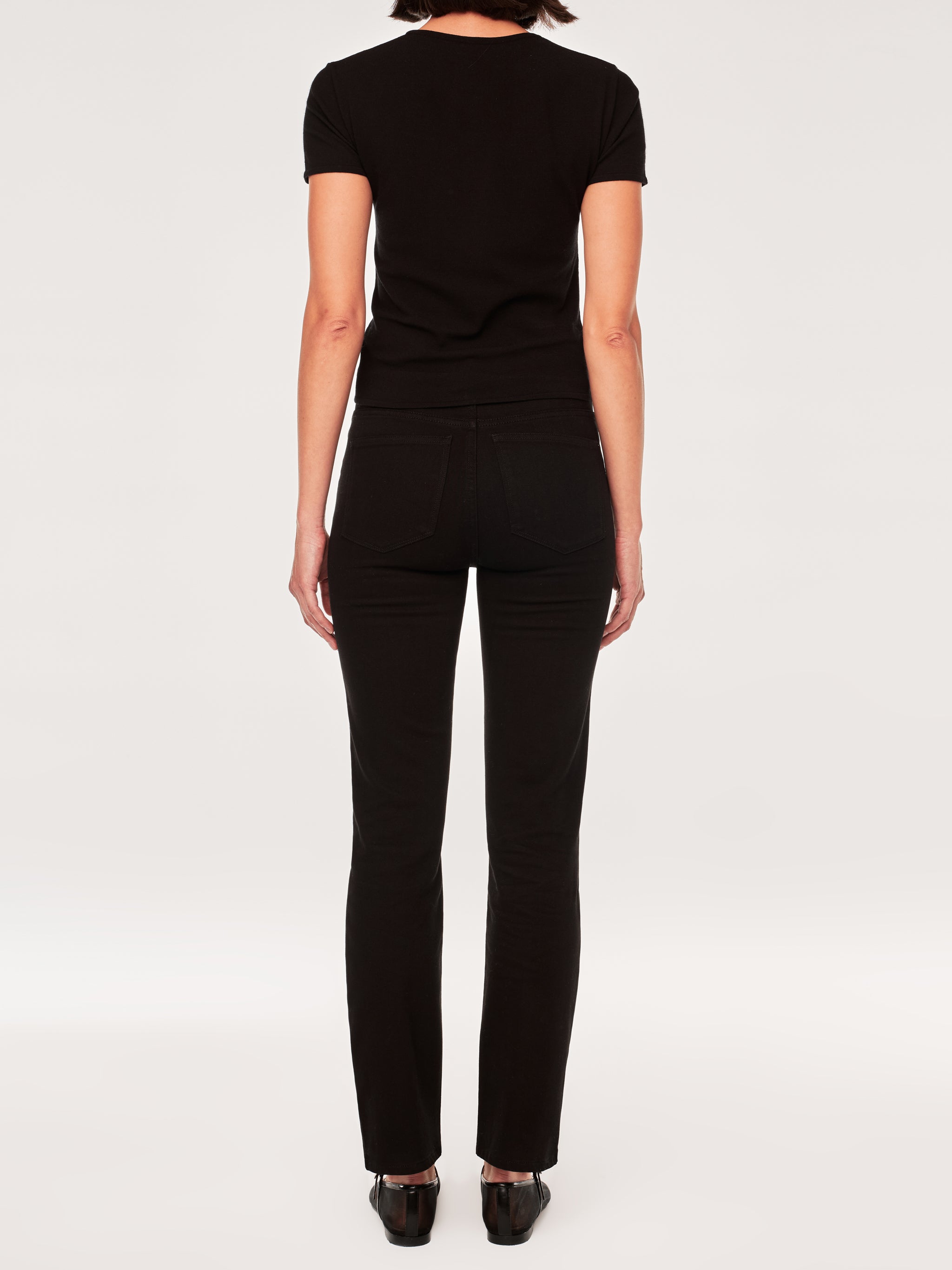 Halle jeans in Black Peach on a model in a black tee, full-length front view in a studio.