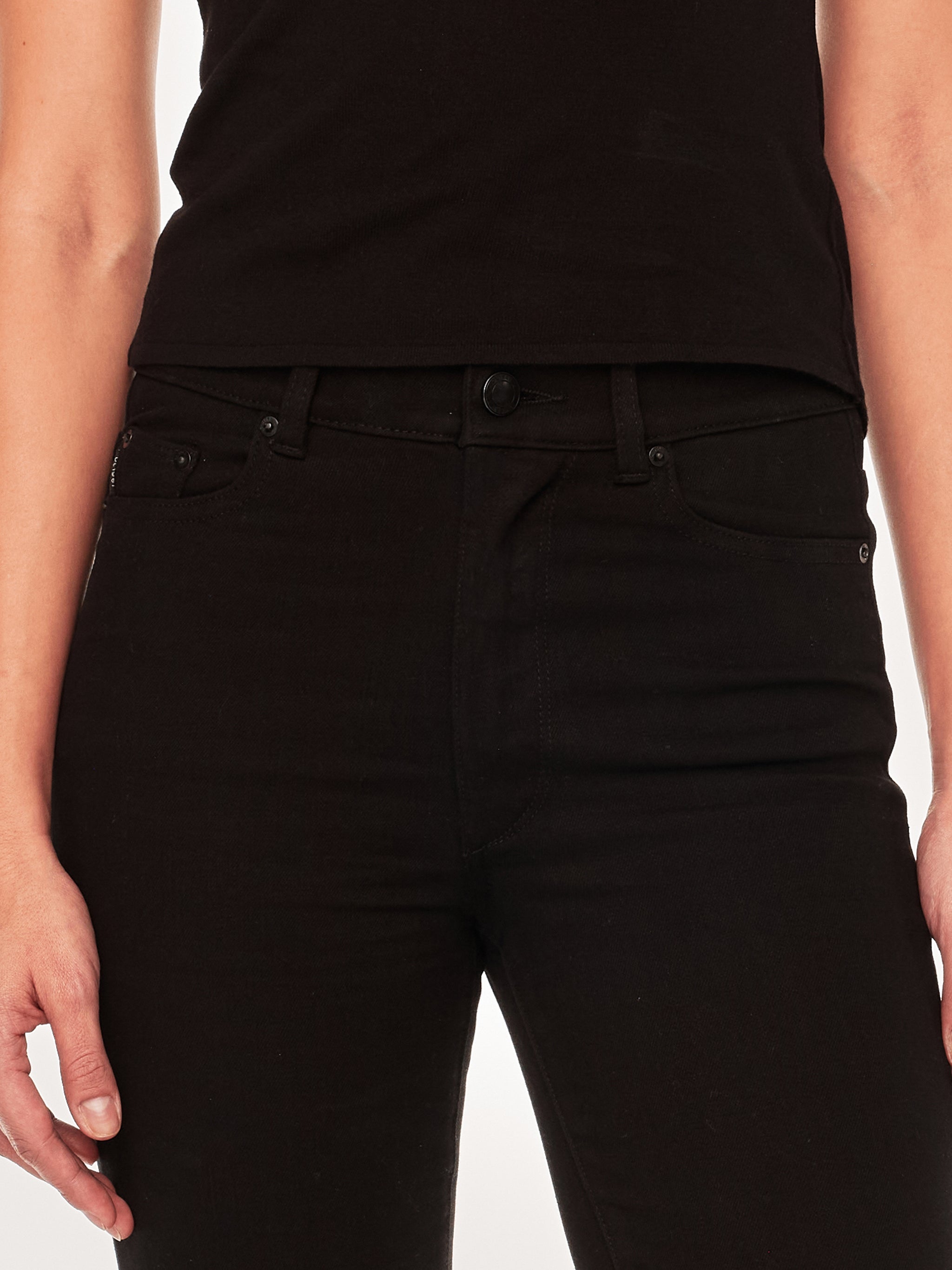 Halle jeans in Black Peach on a model in a black tee, full-length front view in a studio.