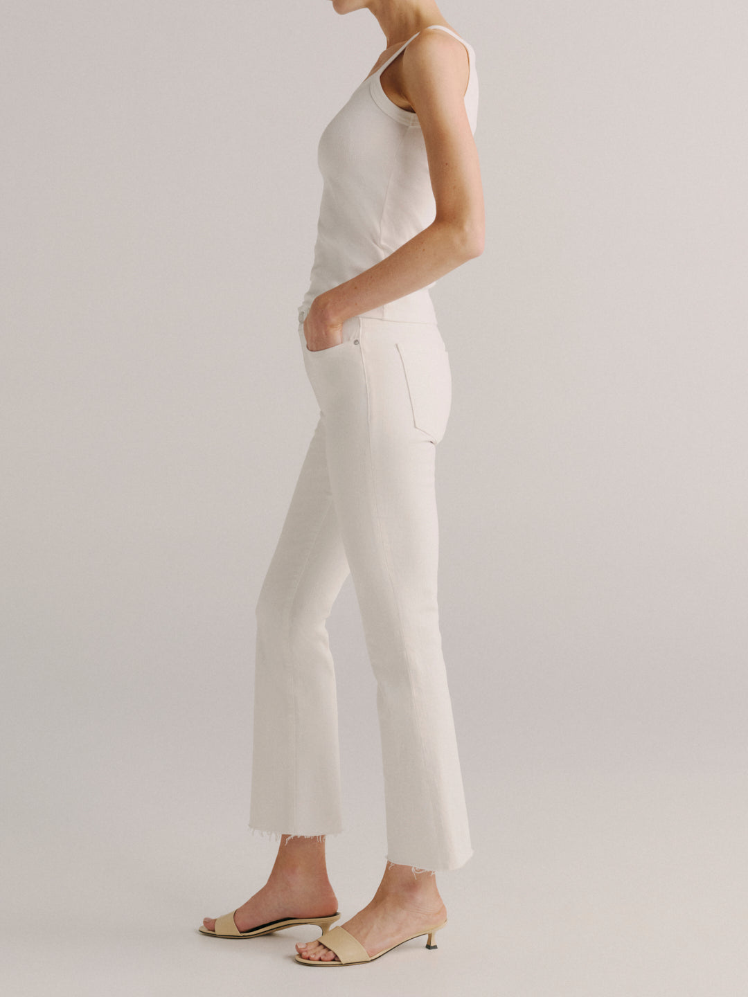 DL1961 women's Bridget Boot High-Rise Crop jeans in white 'White', side view on model.