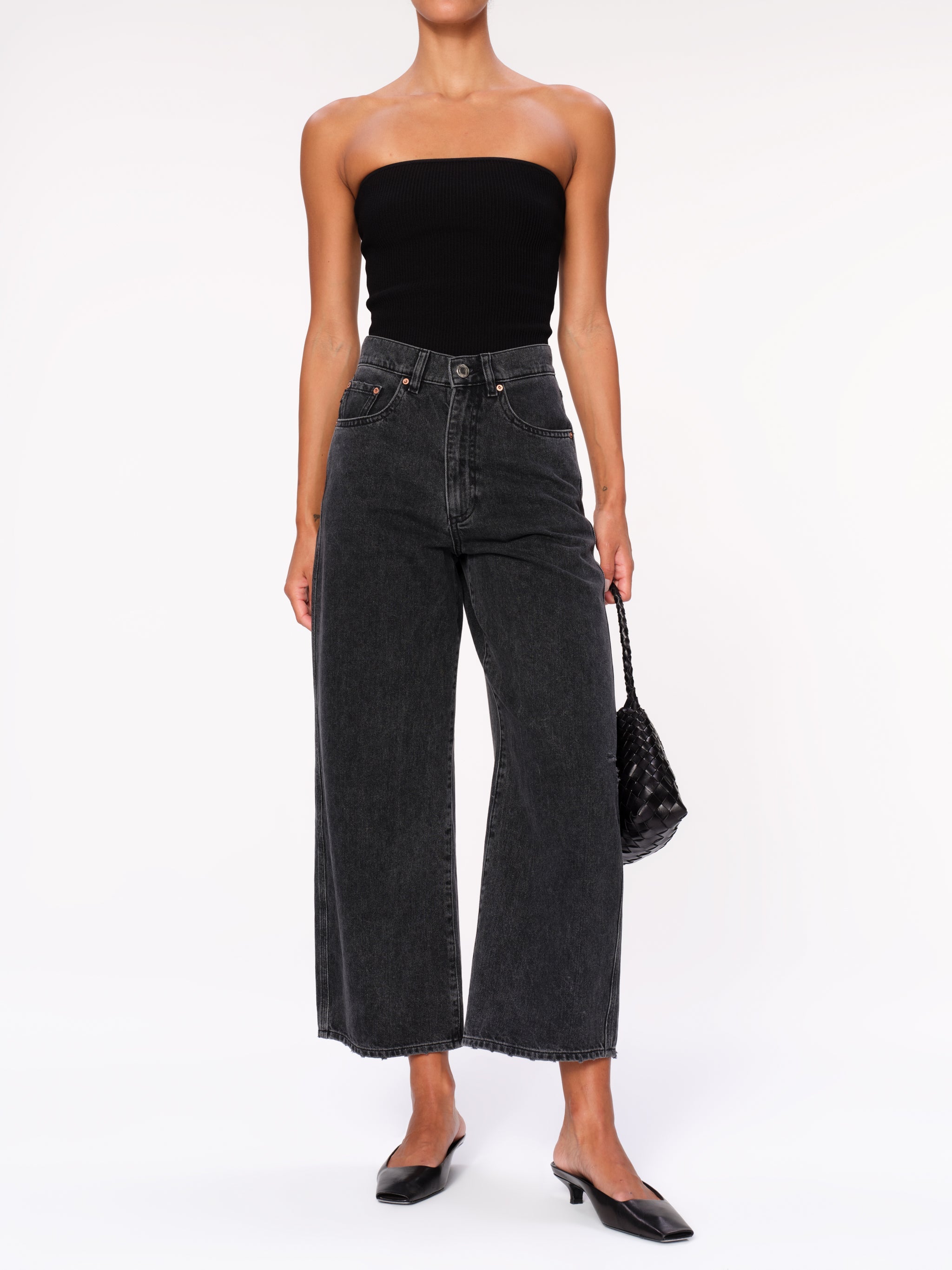 Taylor jeans in Nightshade on a model in a black tube top, full-length front view with kitten heels.