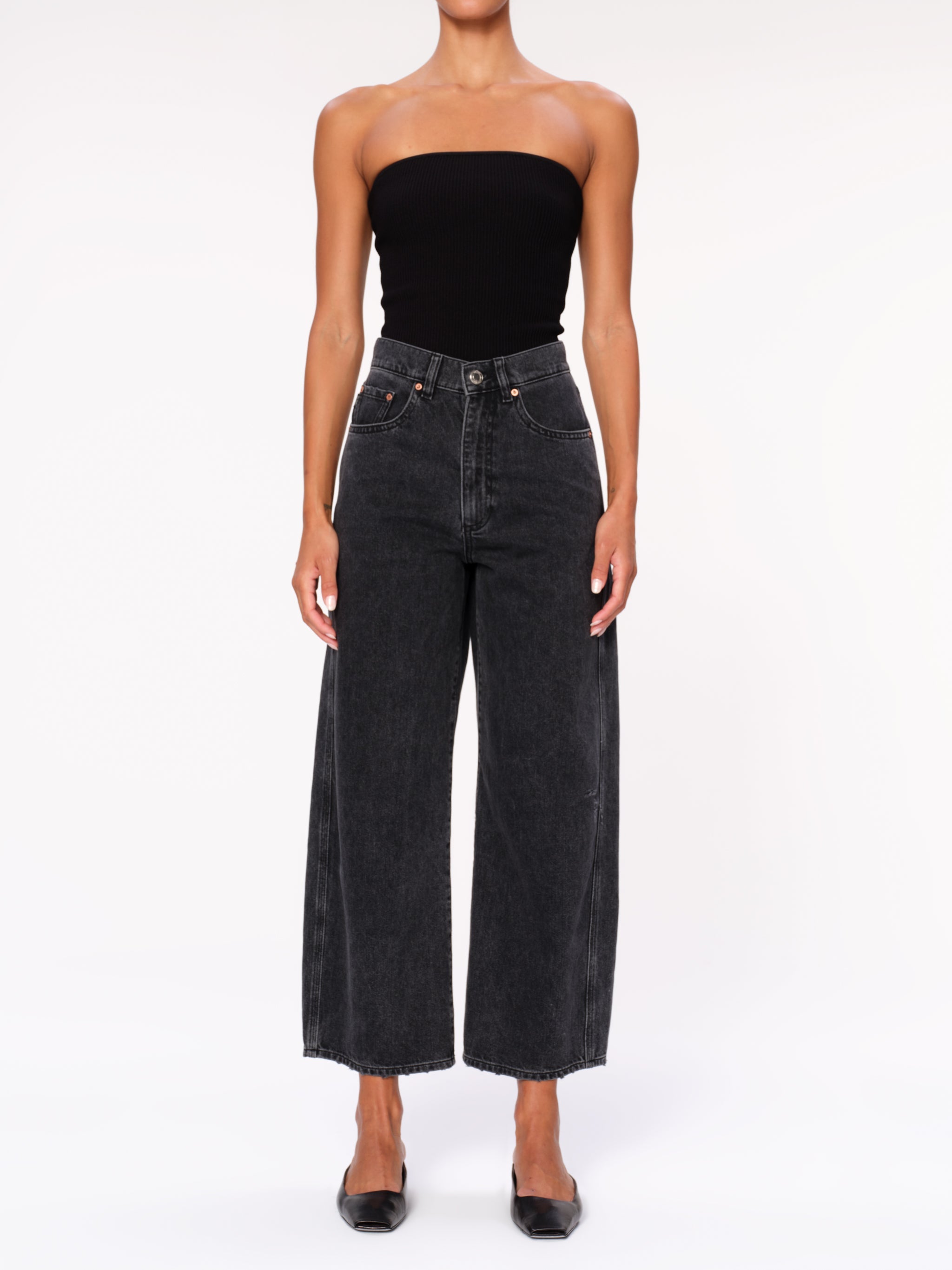 Taylor jeans in Nightshade on a model in a black tube top, full-length front view in a studio.