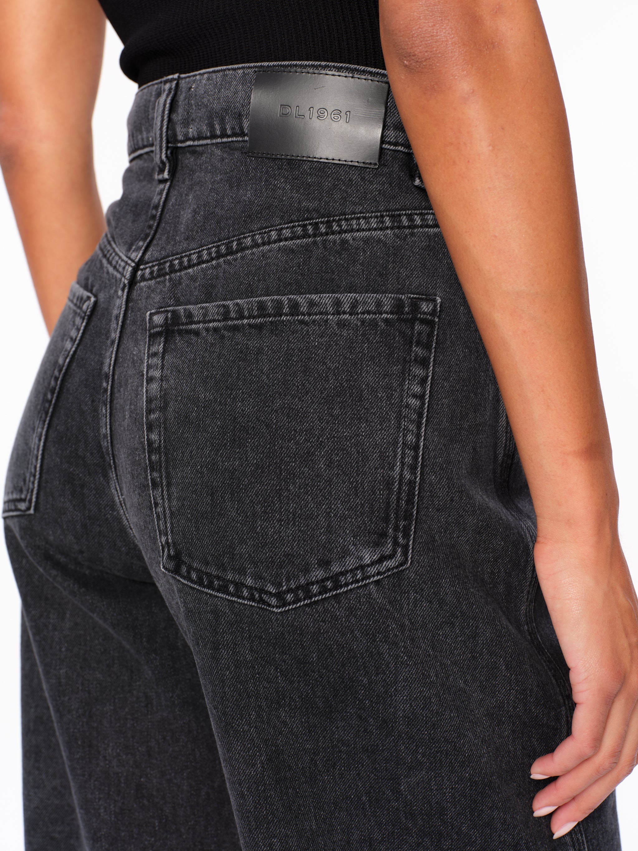 Taylor jeans in Nightshade, close-up of the high-rise waist and back pocket on a model.