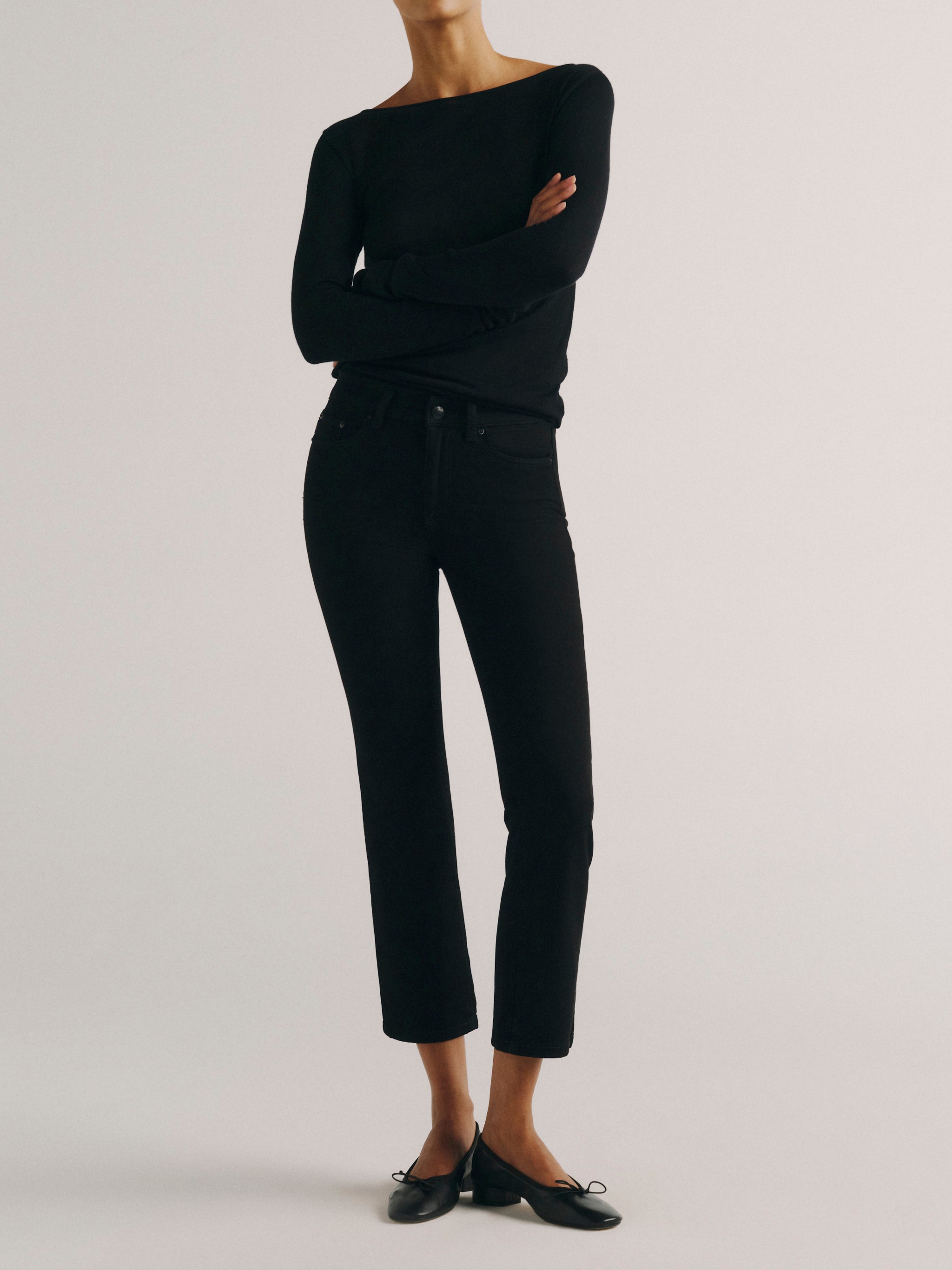DL1961 women's Mara Straight Mid Rise Instasculpt ankle jeans in black, front view styled with a black top and ballet flats.