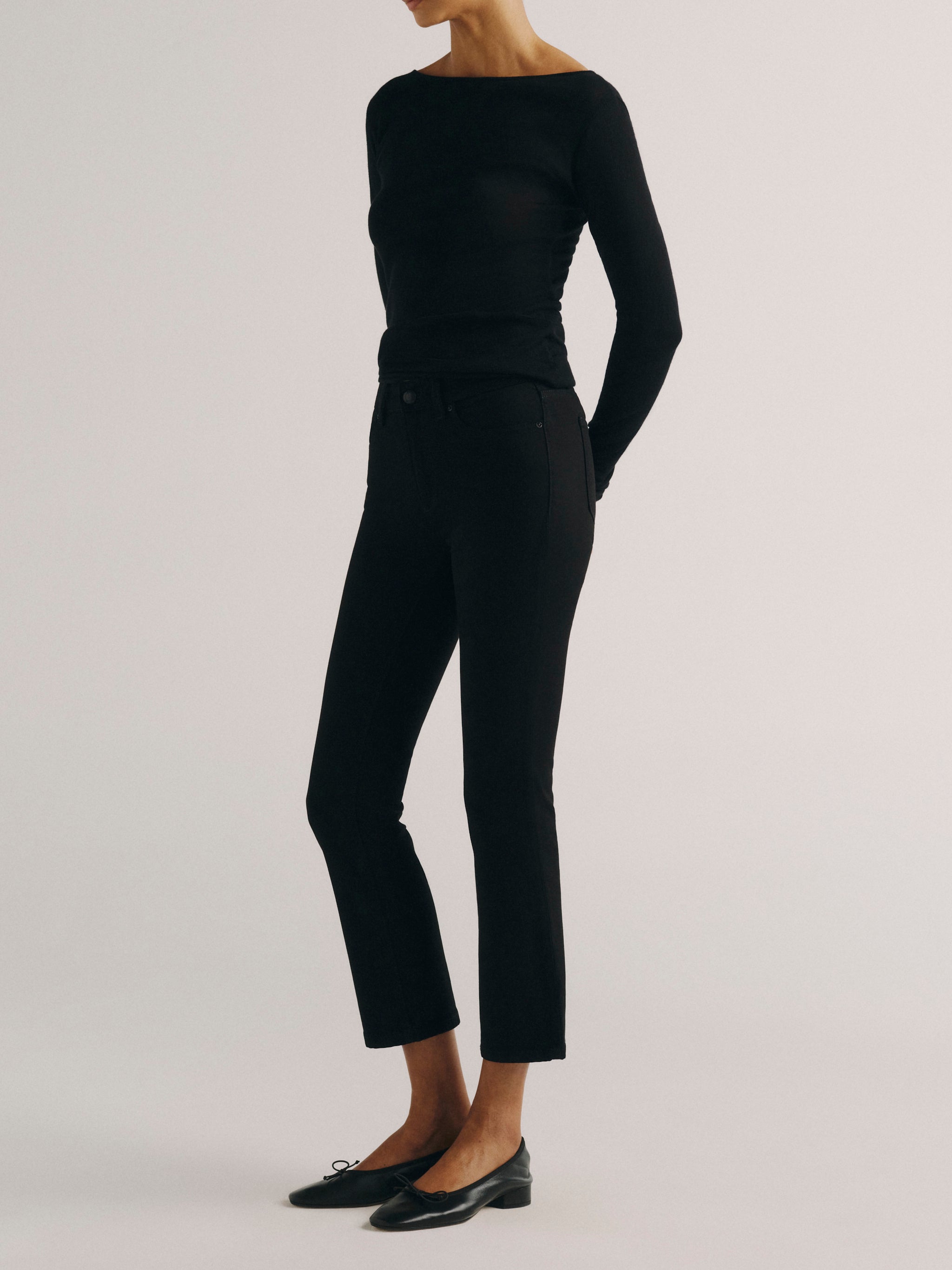 DL1961 women's Mara Straight Mid Rise Instasculpt ankle jeans in black, side view showing the straight ankle-length leg.