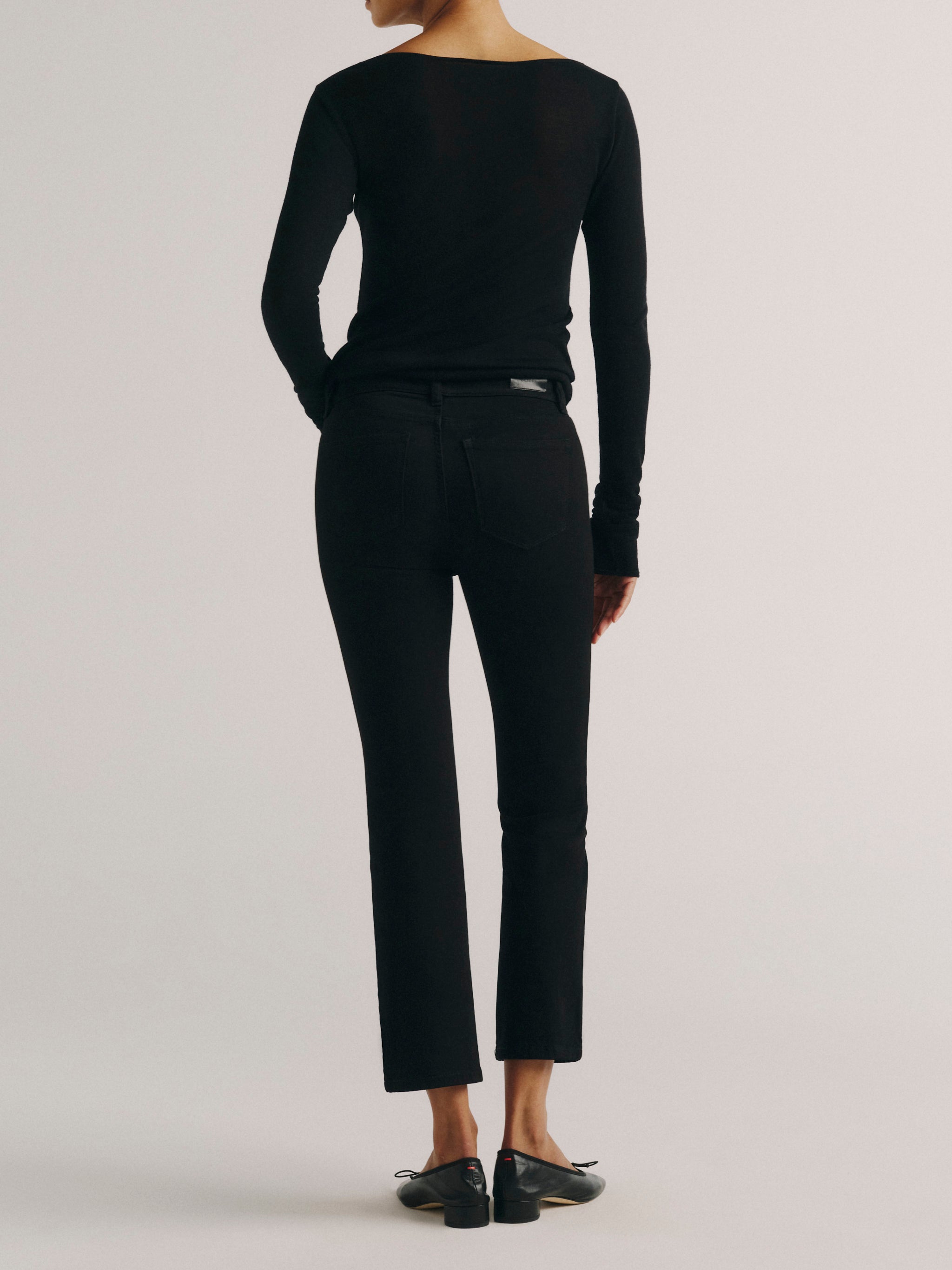 DL1961 women's Mara Straight Mid Rise Instasculpt ankle jeans in black, back view showing the rear pockets and ankle hem.