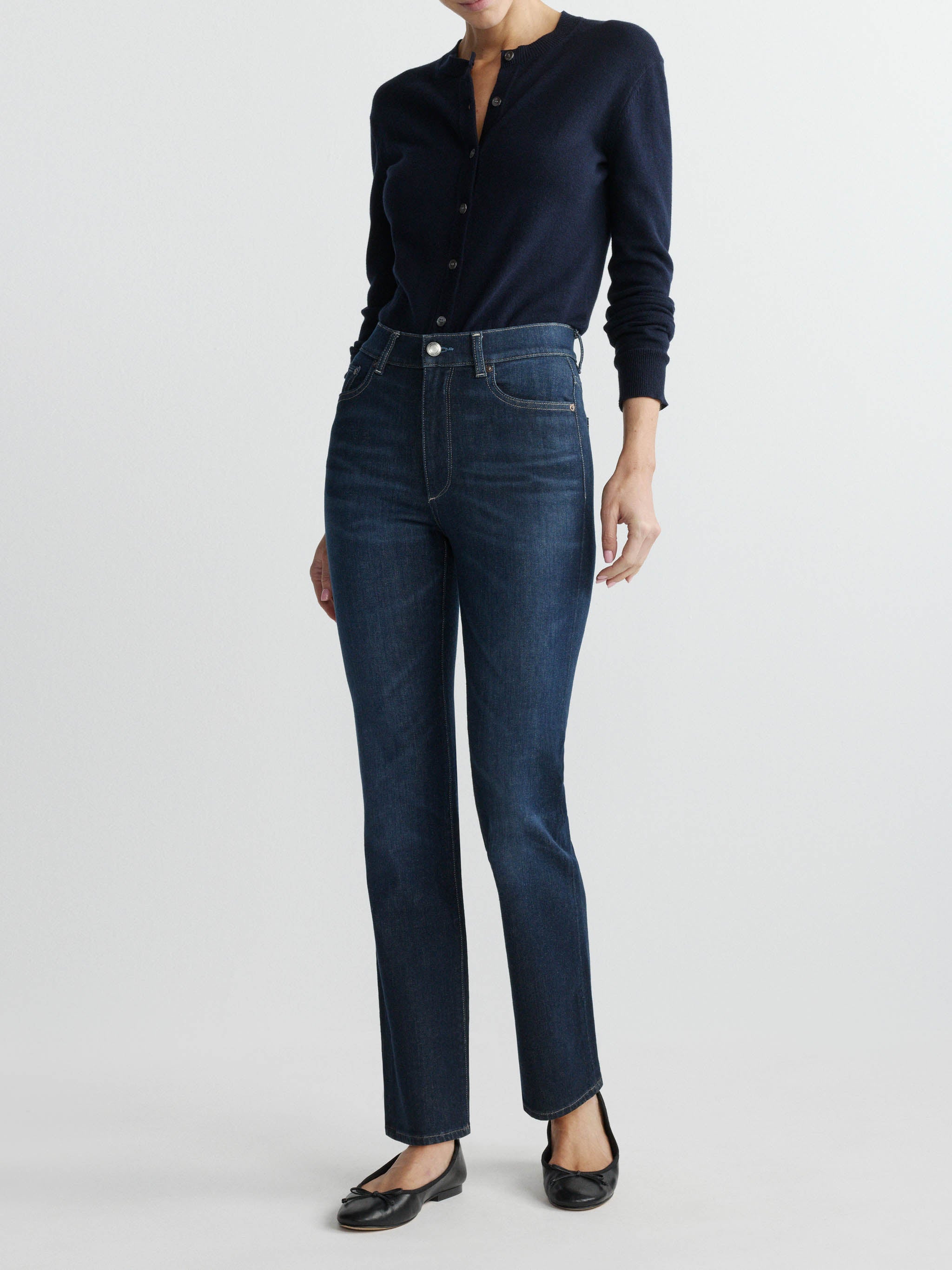 Halle jeans in Crescent Harbor on a model in a navy cardigan, full-length front view in a studio.