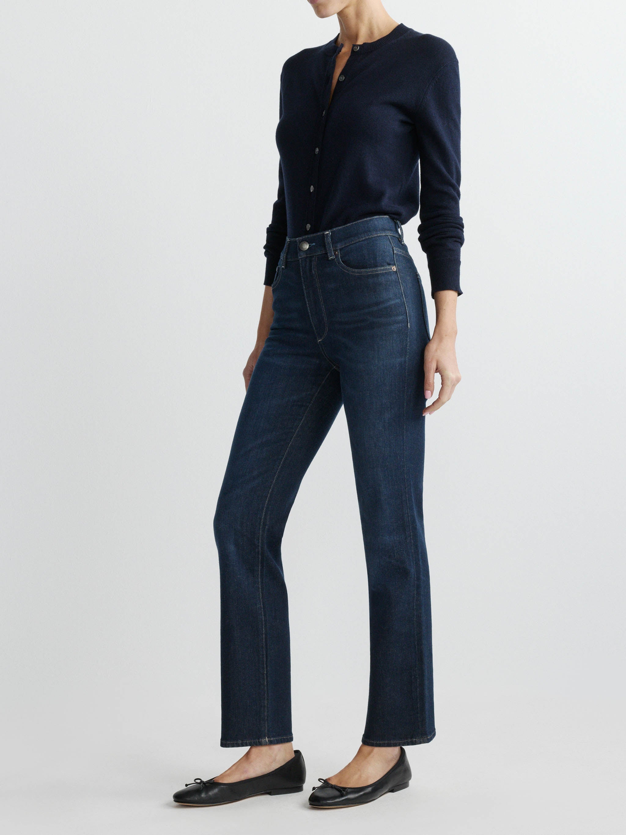 Halle jeans in Crescent Harbor on a model in a navy cardigan, full-length front angle in a studio.