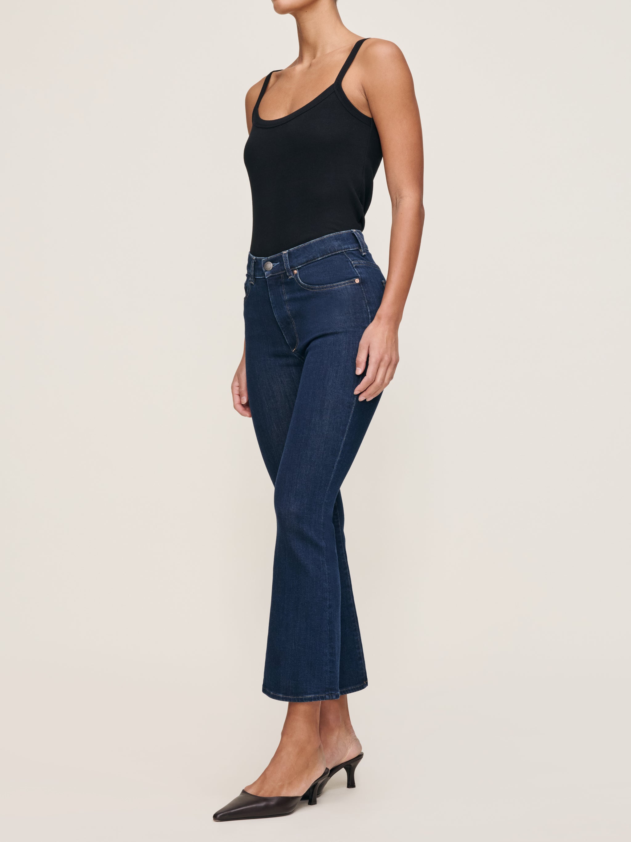 Bridget jeans in Lunar Sky styled with the Ribbed Tank in Black, full-length side view in a studio.