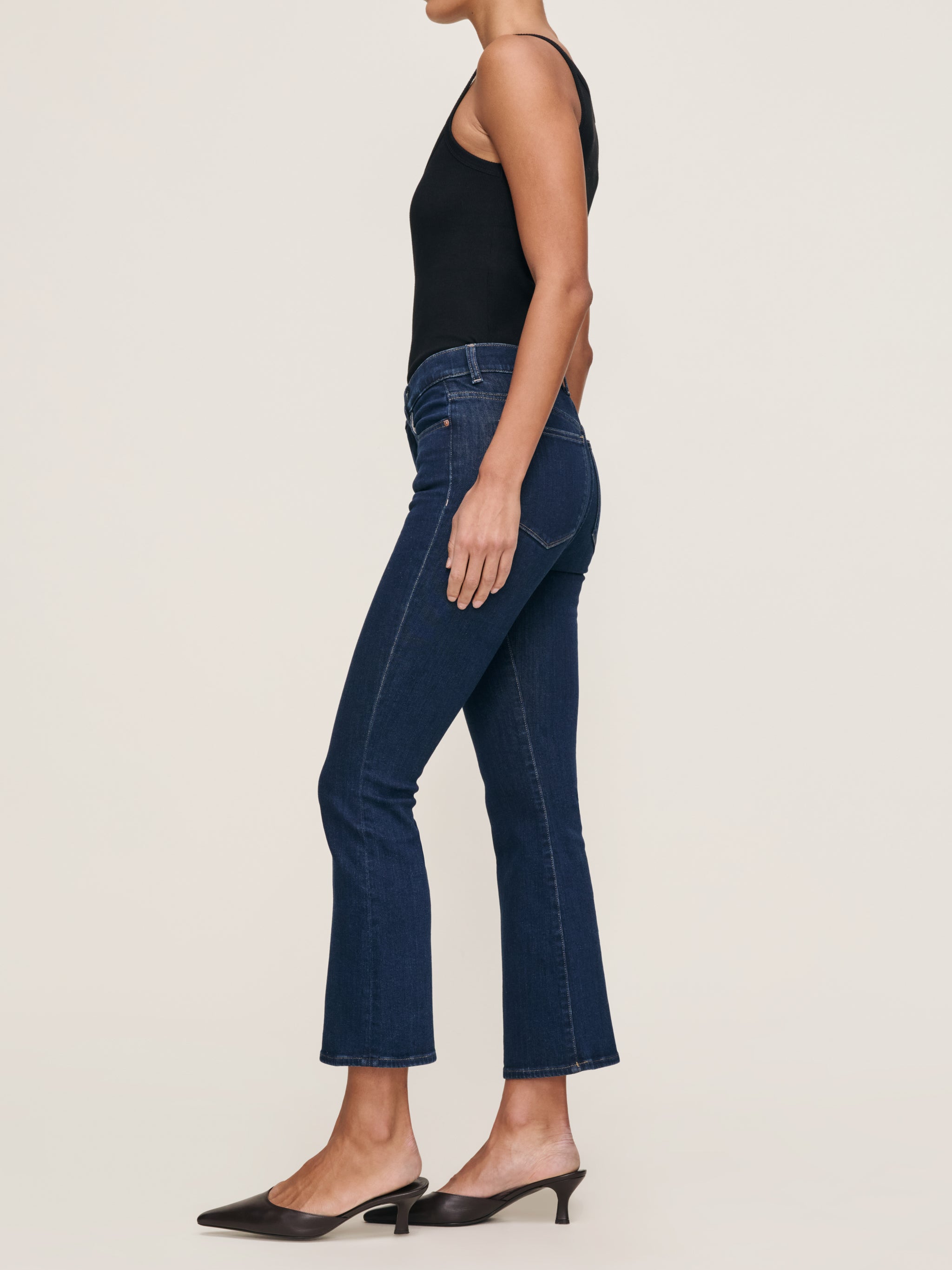 Bridget jeans in Lunar Sky with the Ribbed Tank in Black, full-length side view in a studio.