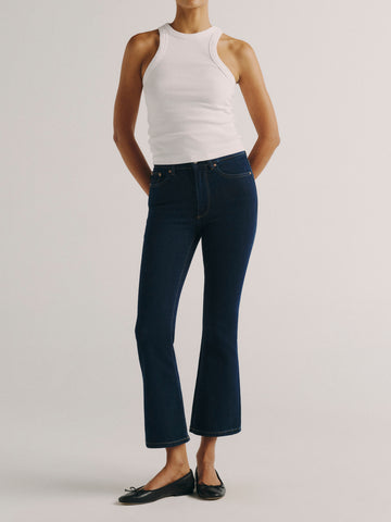 DL1961 women's Bridget Boot High Rise Instasculpt crop jeans in dark indigo 'Lunar Sky', front view styled with a white tank and black flats.