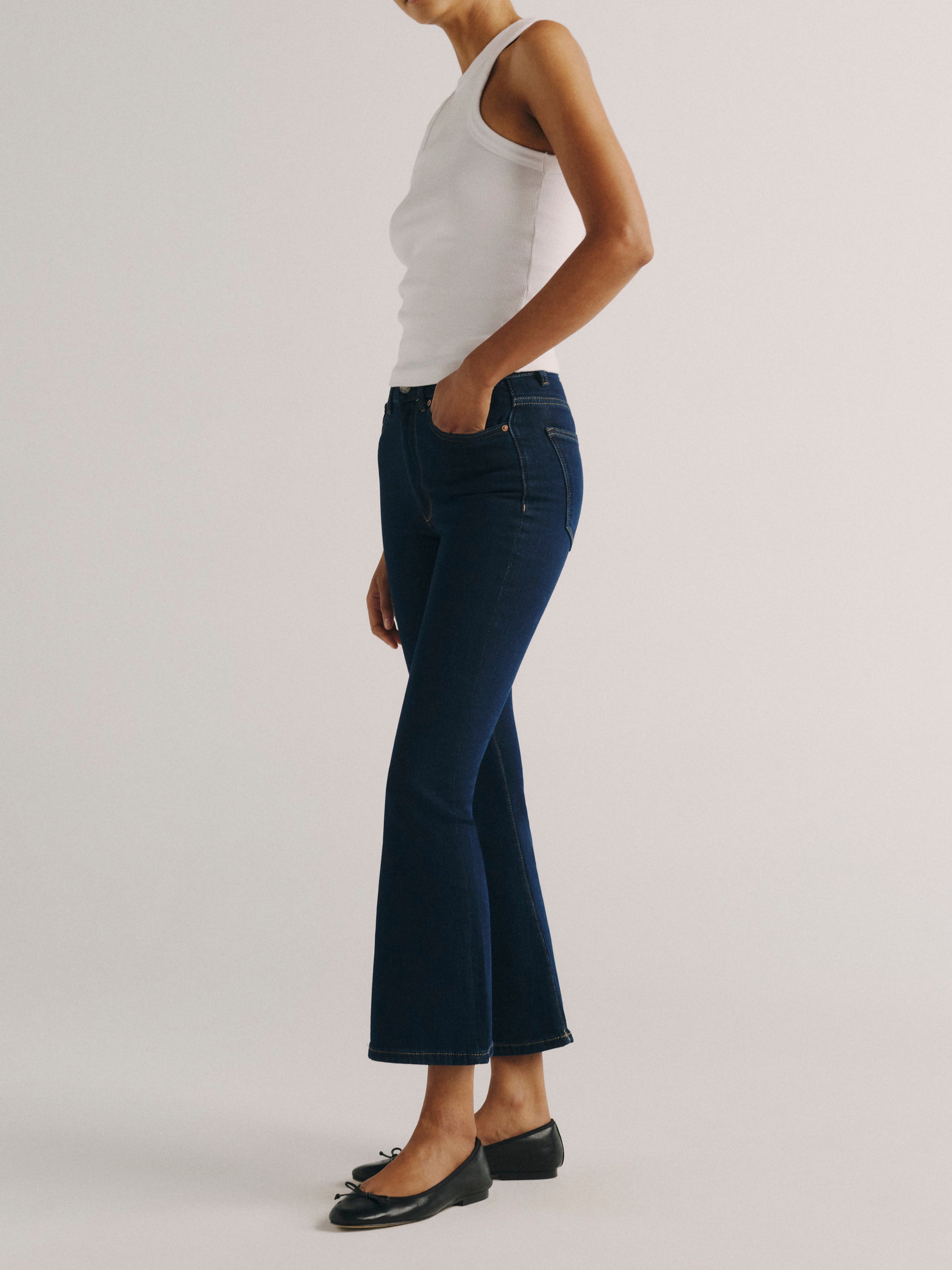 DL1961 women's Bridget Boot High Rise Instasculpt crop jeans in dark indigo 'Lunar Sky', side view showing the cropped flare.