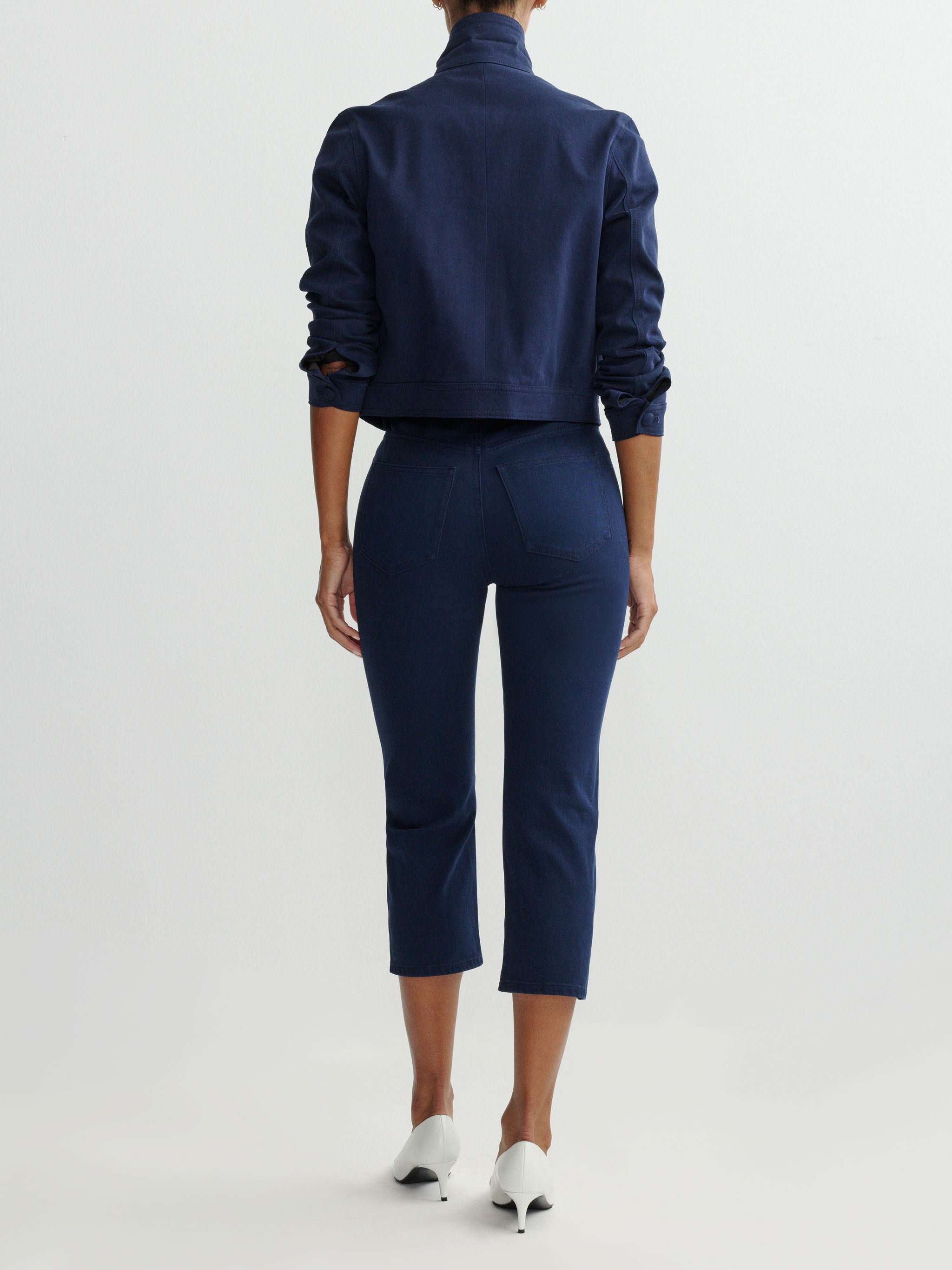 Person wearing a navy blue outfit on a white background