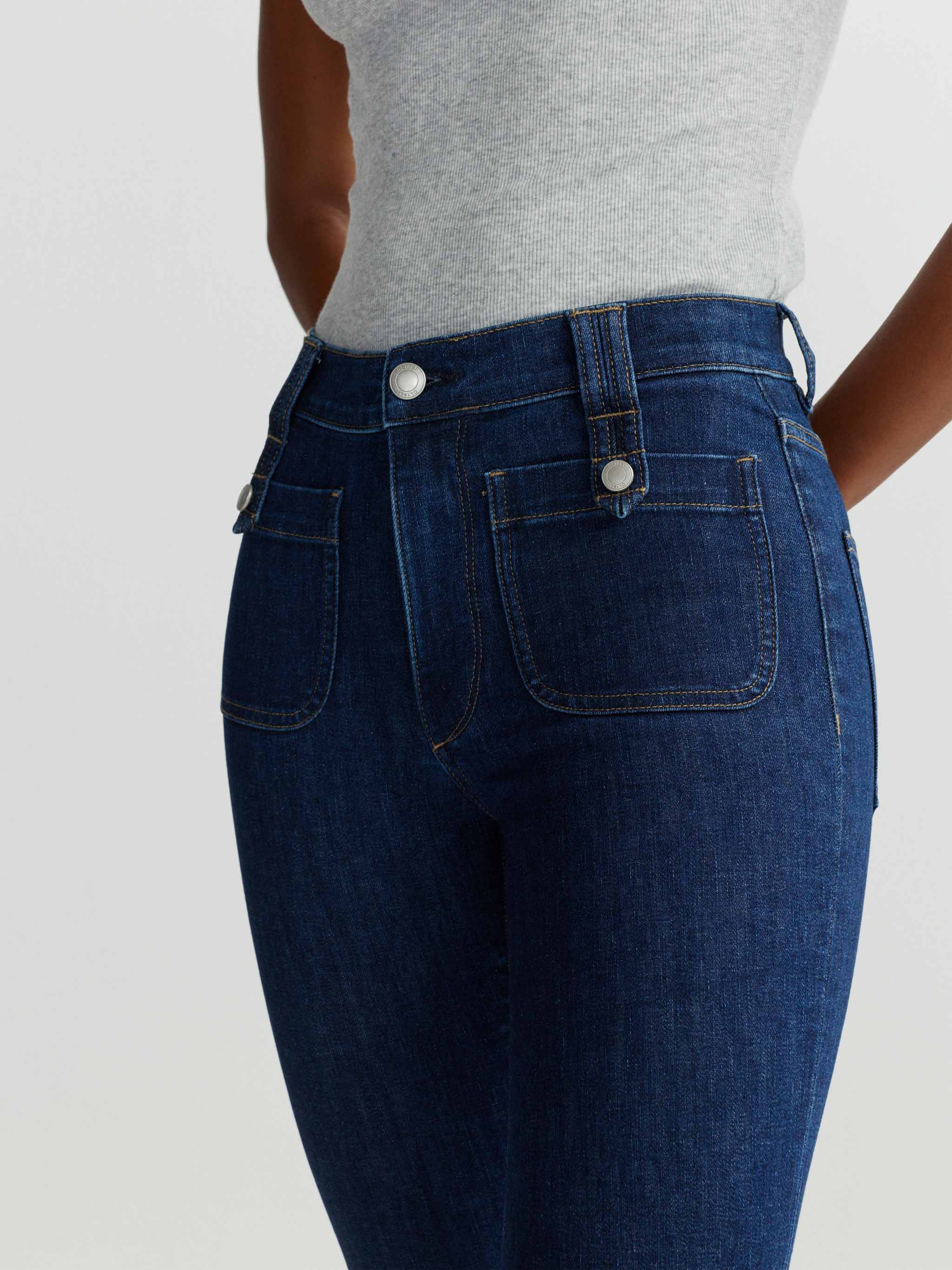 Blue jeans worn by a person on a white background