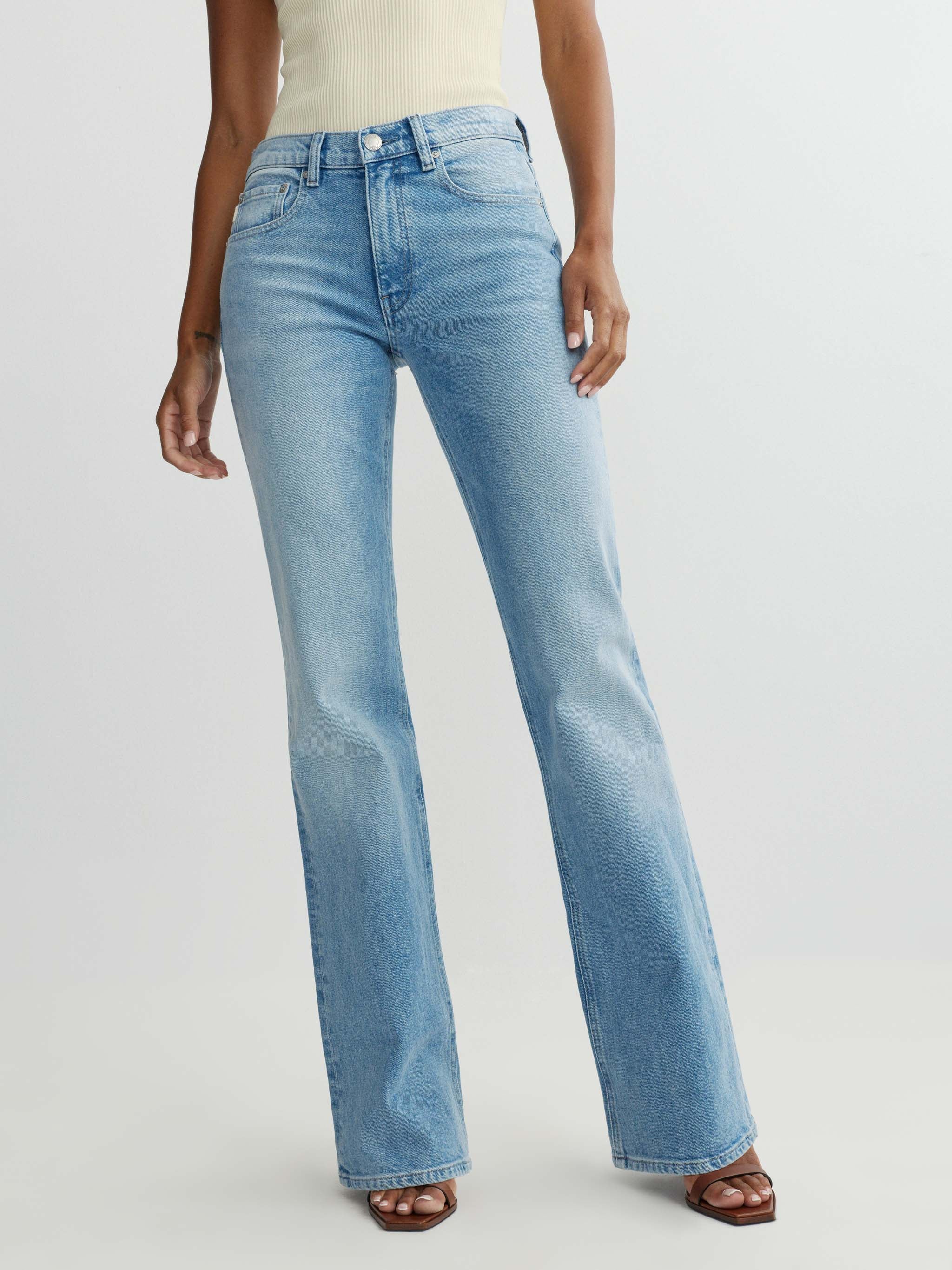 Light blue jeans worn by a person on a white background