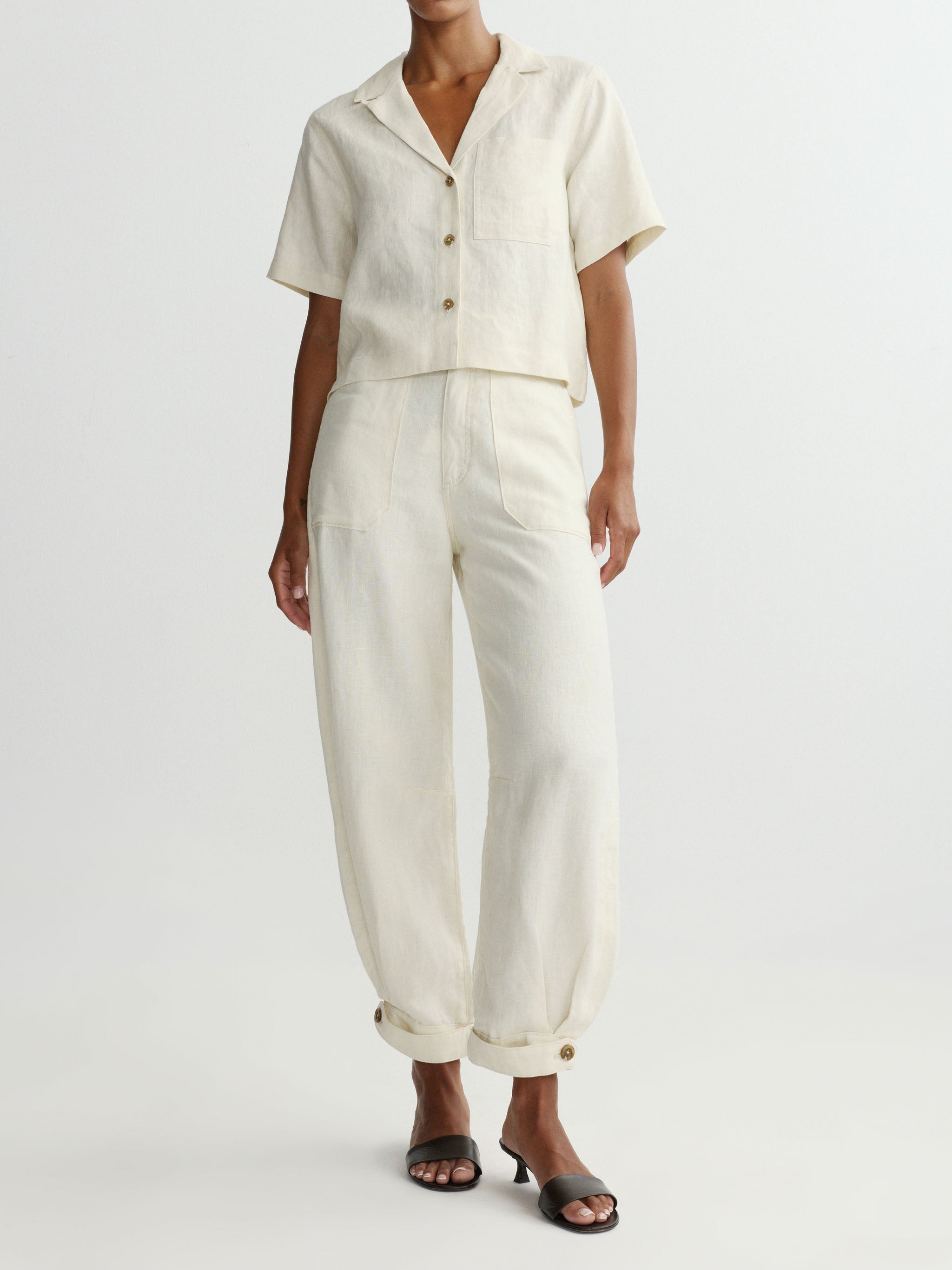 Person wearing a white outfit with a plain background