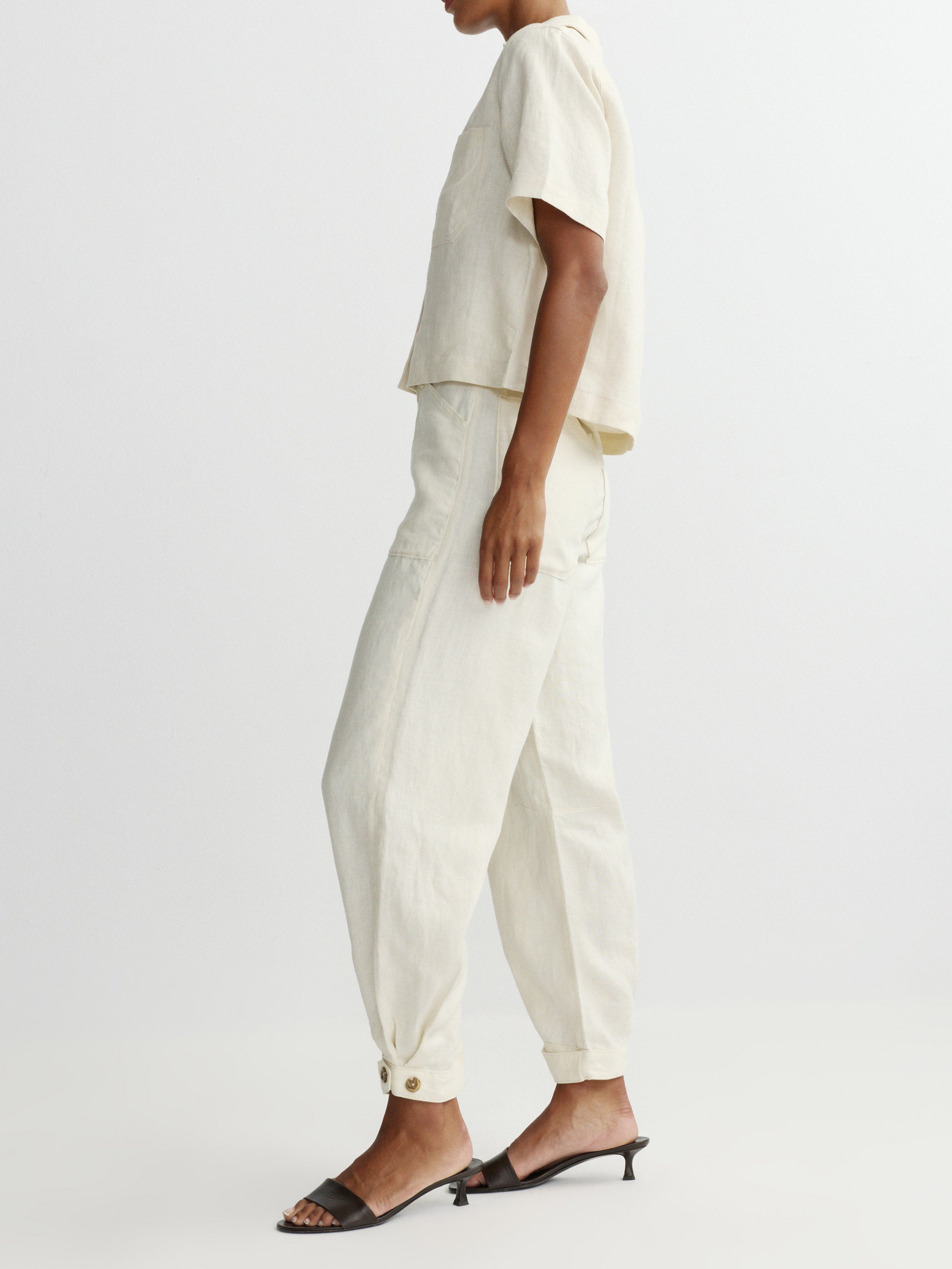 Person wearing a white outfit with a plain background