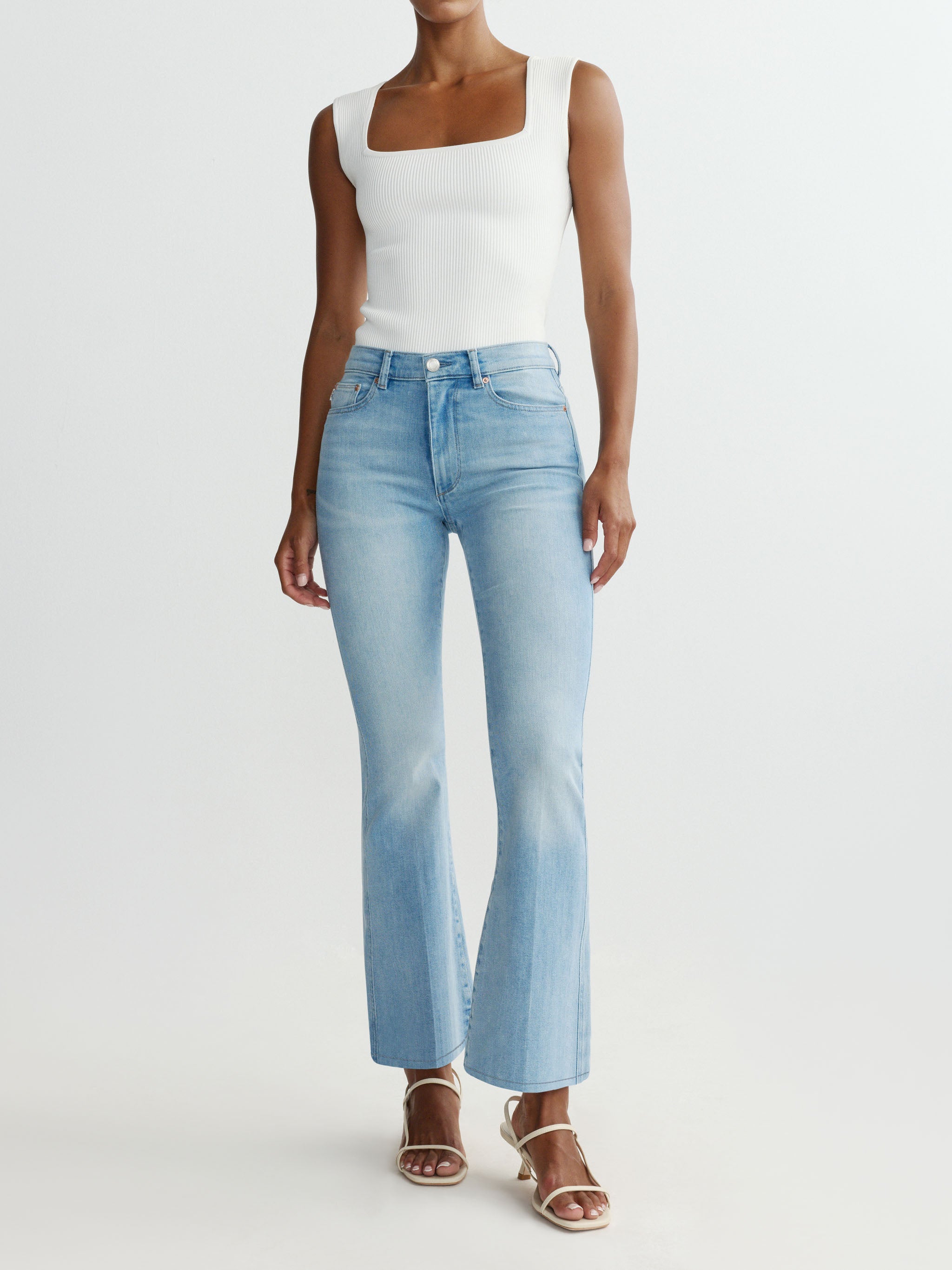 Light blue jeans worn by a person on a white background