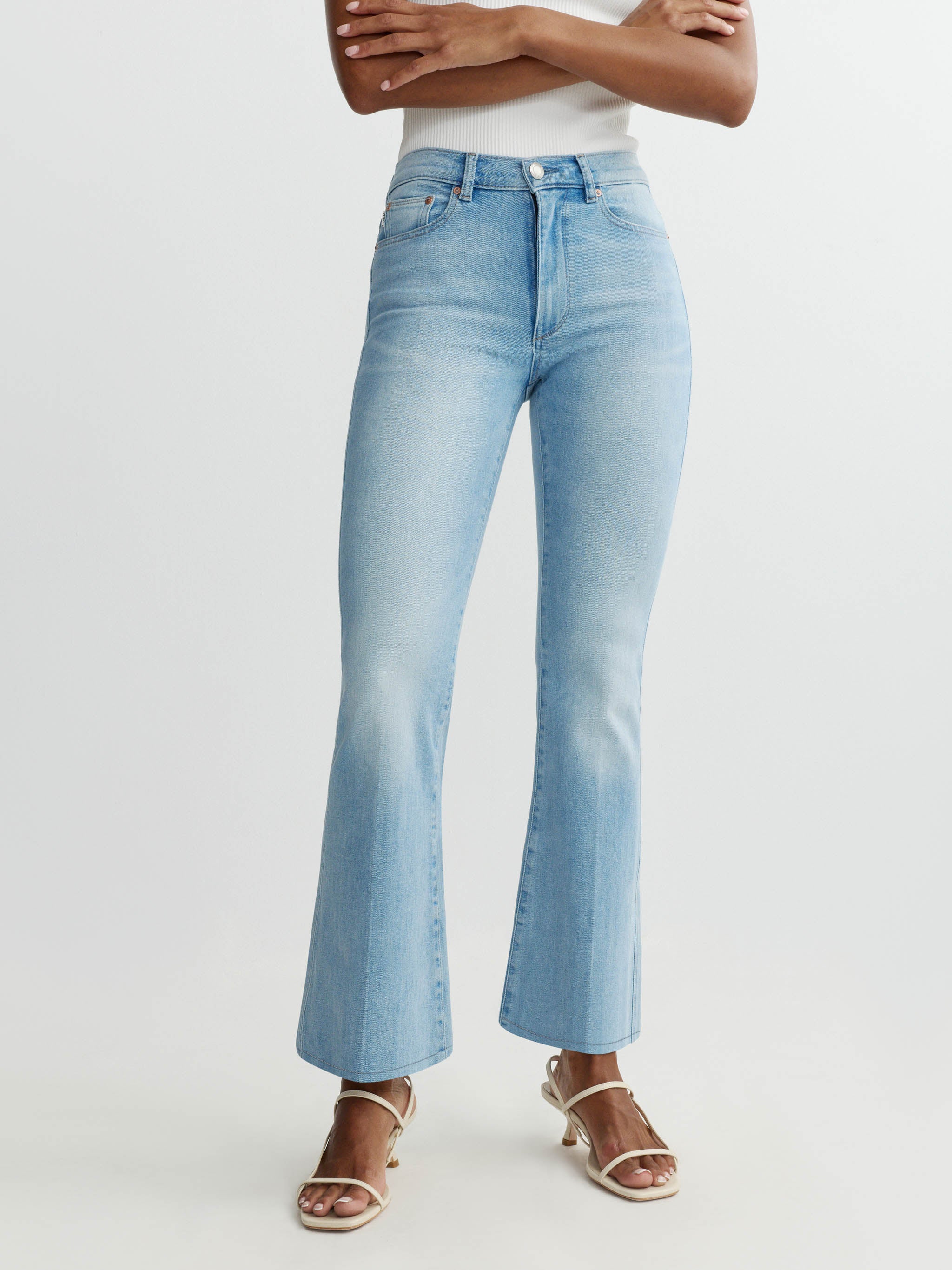 Light blue jeans worn by a person on a white background