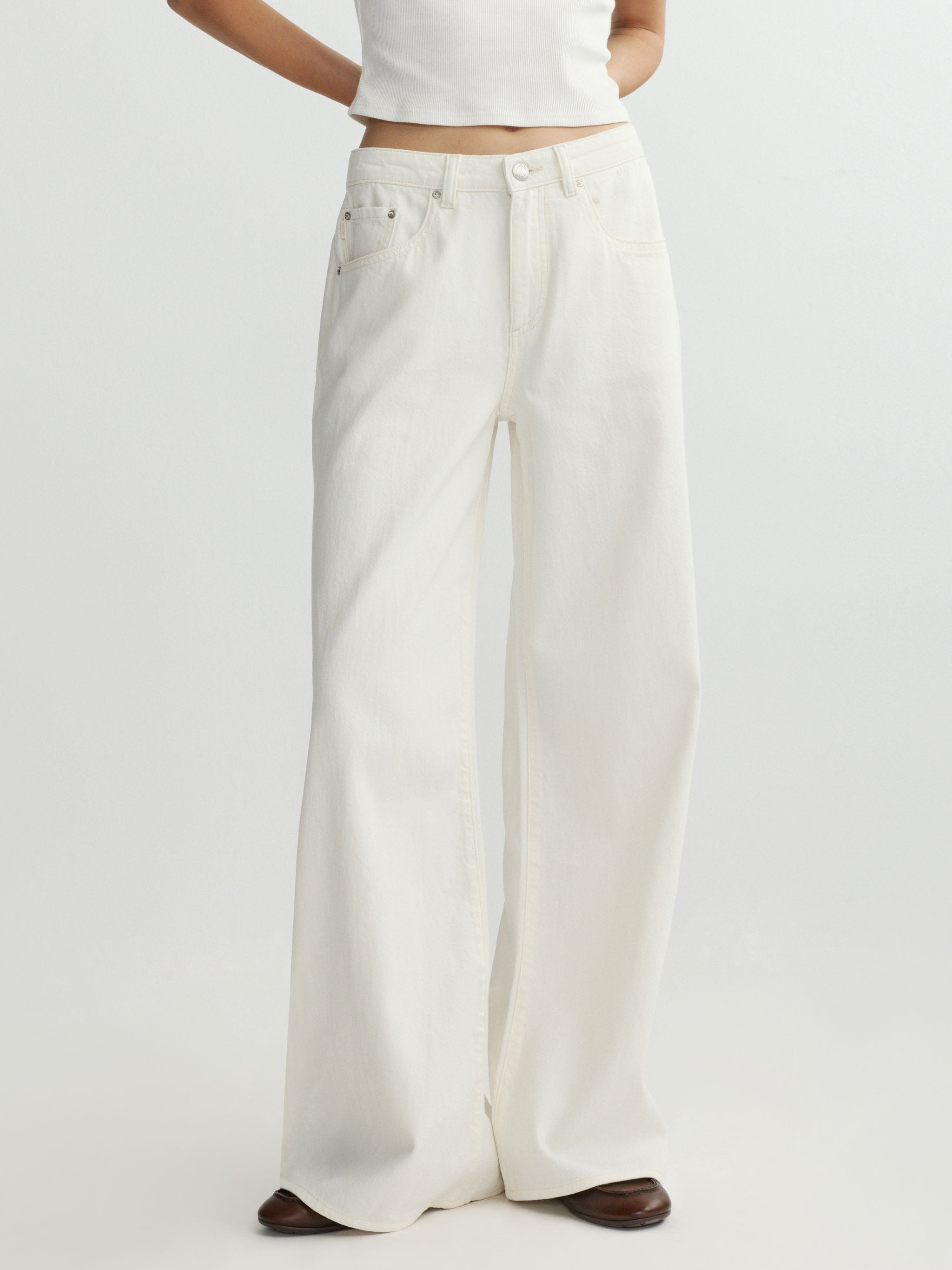 White wide-leg pants worn by a person on a white background