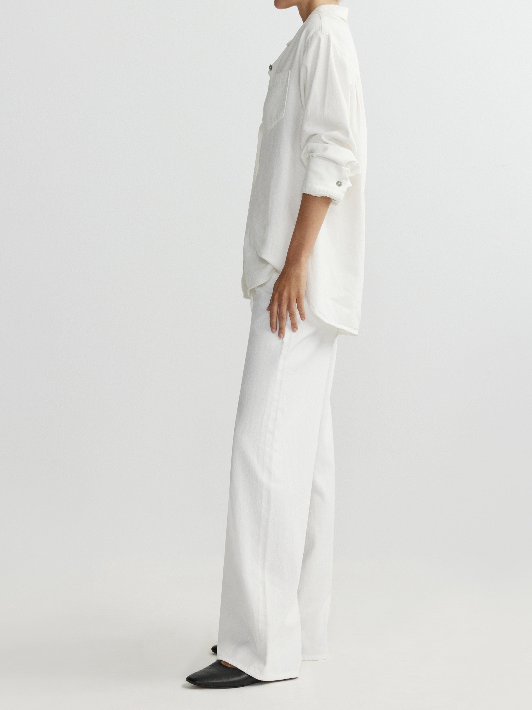 Person wearing a white outfit on a plain background