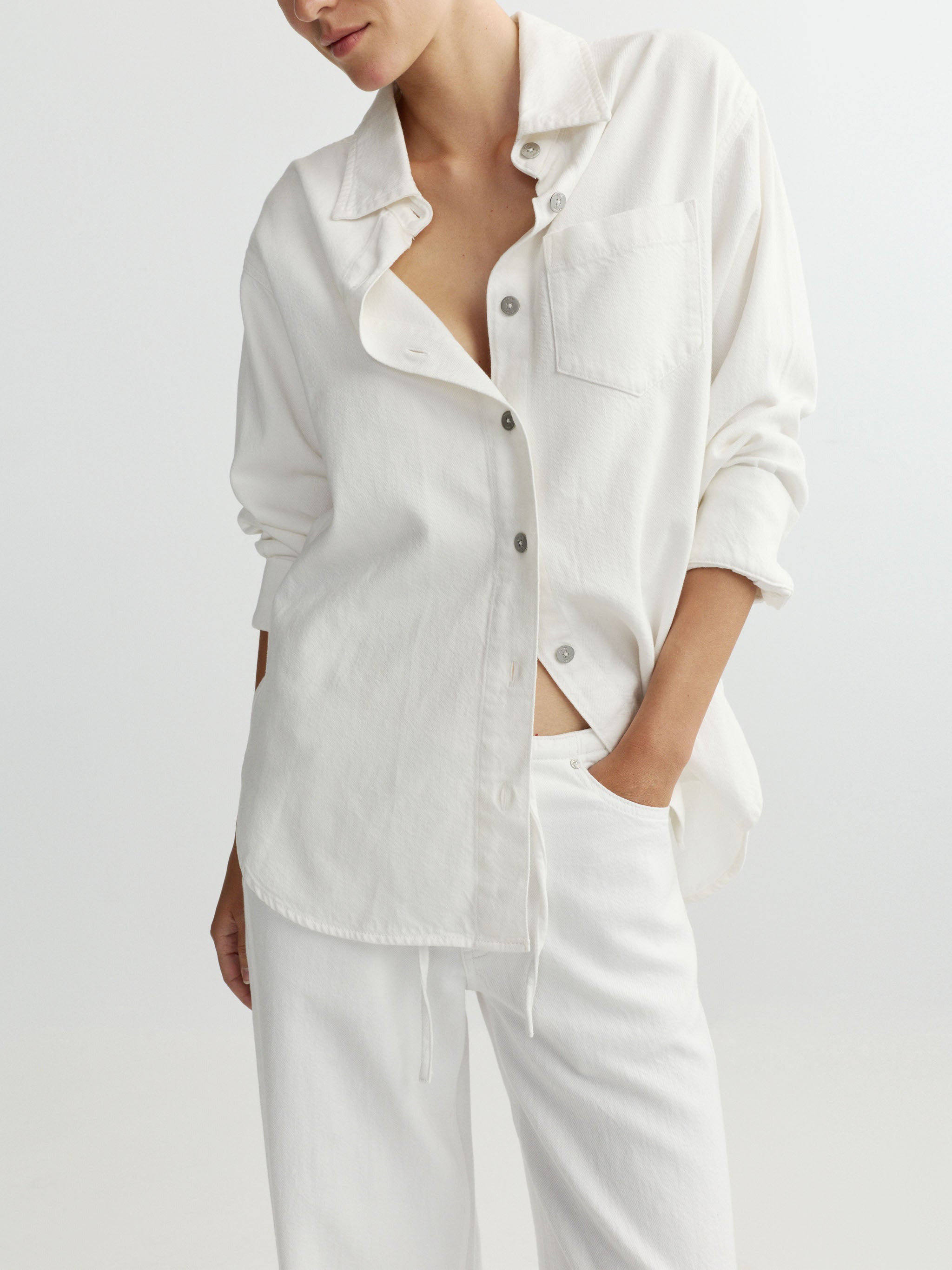 White button-up shirt and pants on a plain background